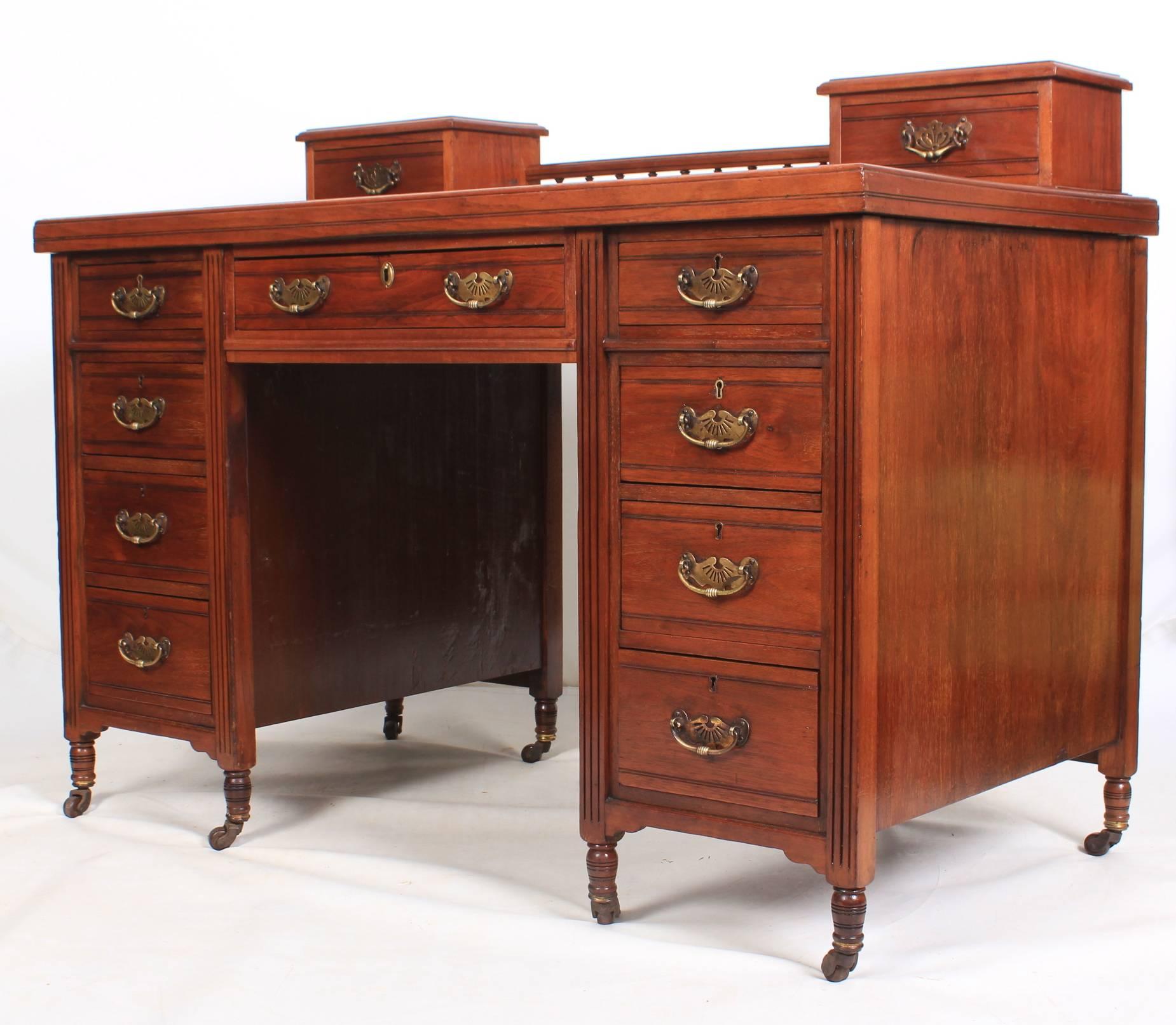 English, circa 1900.
This pedestal desk is offered in showroom condition.
It can be broken down into three parts for easy transportation.
The top has a small drawer either side with a galleried back in between.
There are three drawers along the