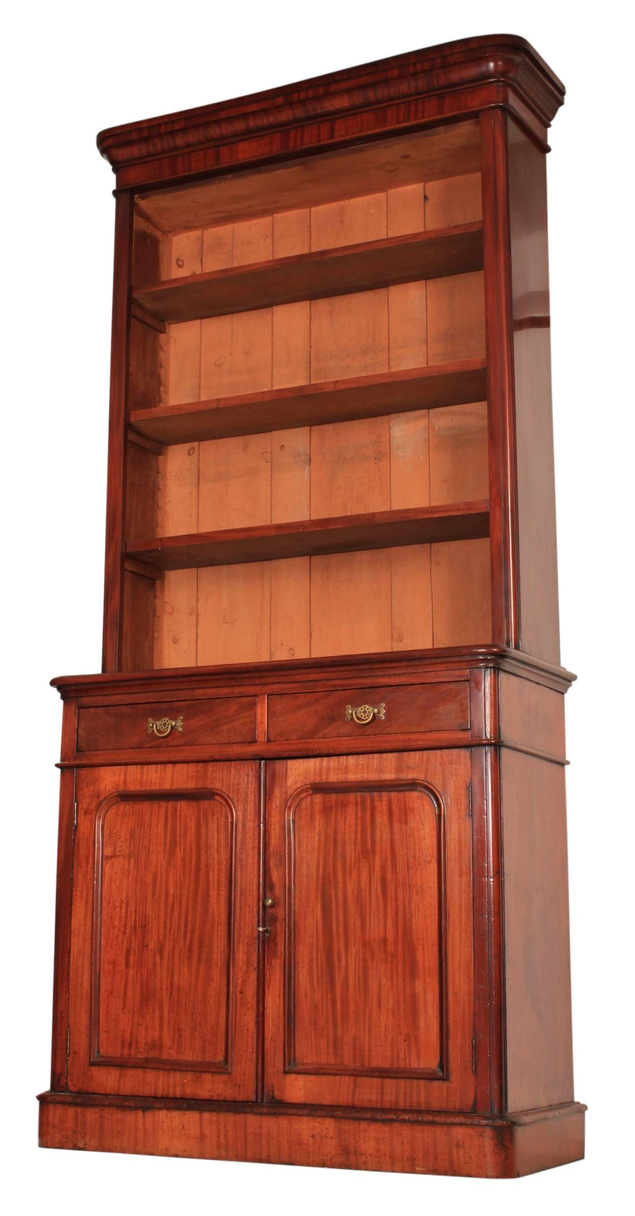 English, circa 1860.
A very tall mahogany bookcase in great original condition.
Cornice top over three adjustable shelves and on a base of two drawers over two doors.
The drawers are of solid mahogany dovetailed construction, with brass