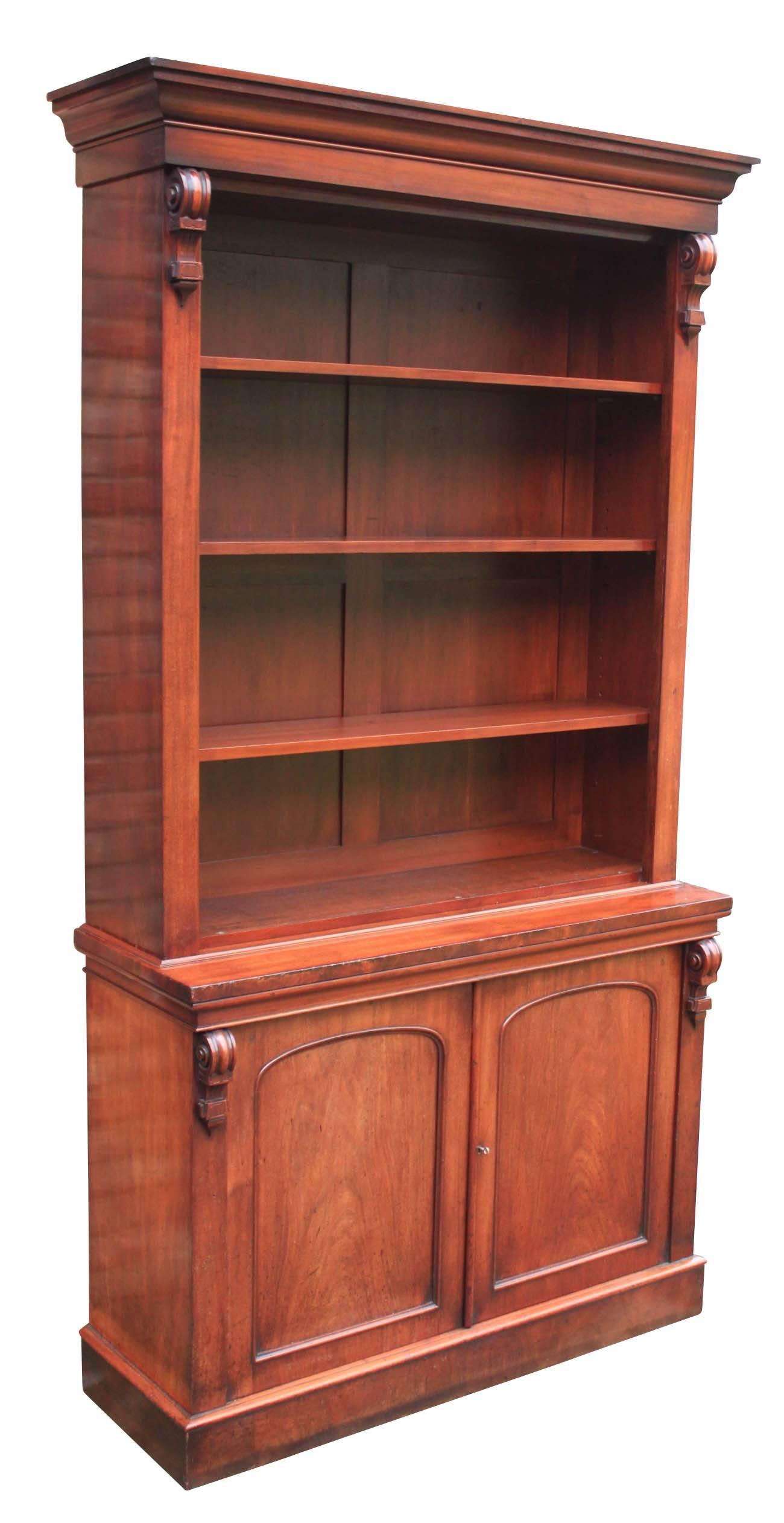 English, circa 1850.
A very tall solid bookcase in superb condition.
Cornice top over three adjustable shelves, with carved corbels either side.
The base has a cupboard with panelled doors which open to reveal a single removable shelf.
The doors