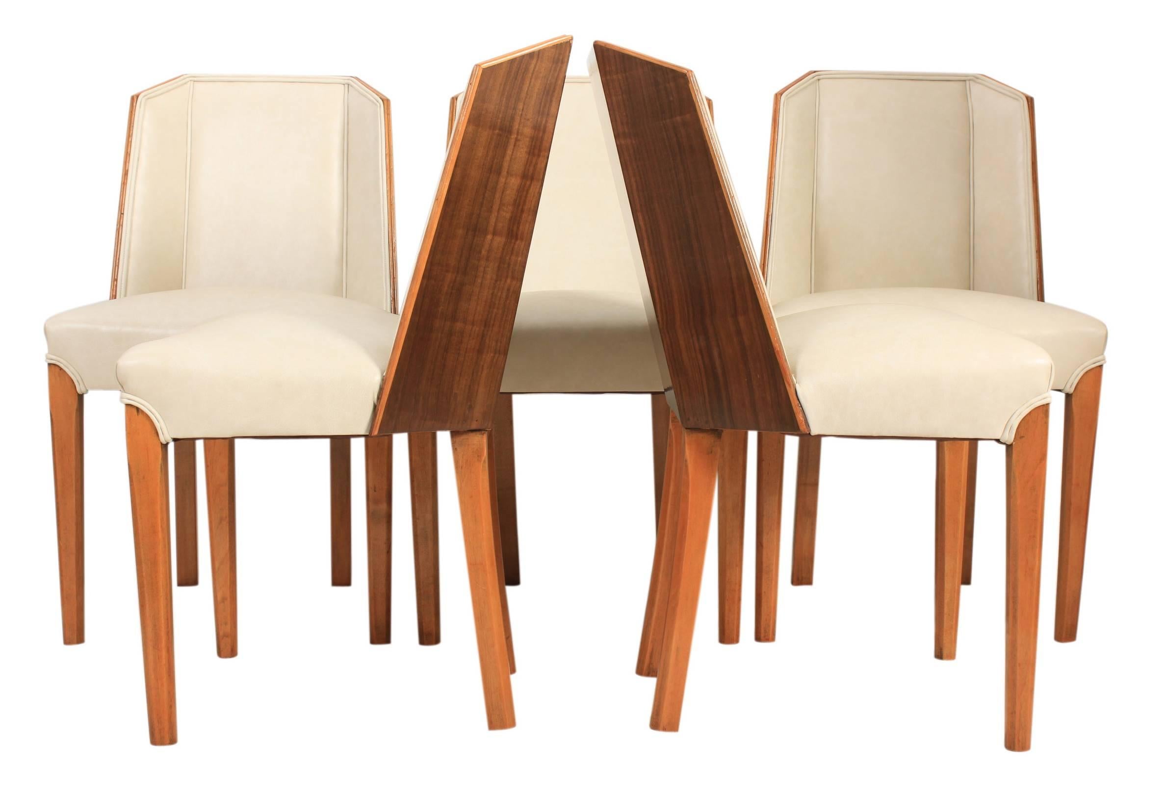 English, circa 1930.
These Art Deco dining chairs are in superb showroom condition.
Boasting fantastic walnut backs and professionally upholstered cream leather seats with double piped edging.
On square tapered legs.

Measures: W 52cm/20.5