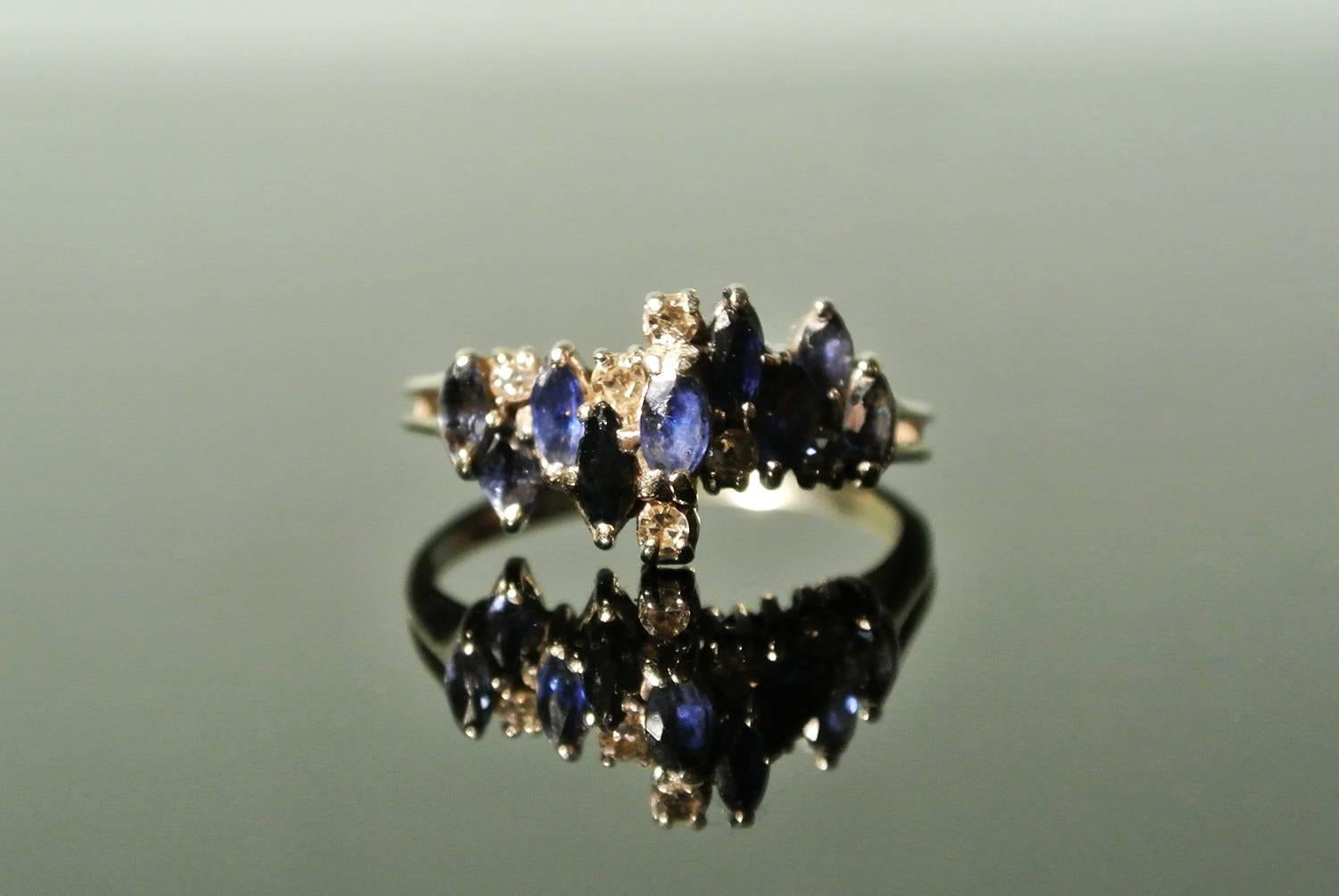 A lovely sapphire and diamond Art Deco ring with all original gemstones.

Set with nine marquise cut sapphires ranging from rich royal blue to a clear delicate cornflower color and six crystal clear round brilliant cut claw set diamonds. The white