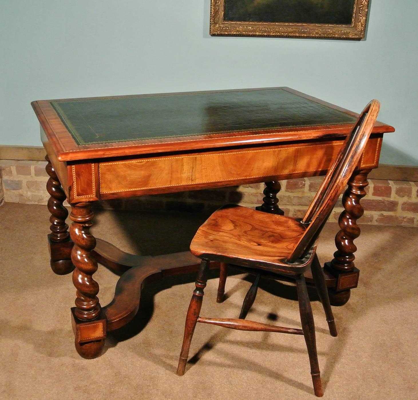 A superior quality writing desk of small proportion and with a beautiful rich color to the walnut. 

The desk dates from circa 1900 and has a deep navy leather skiver in very good condition with a lovely gold tooled border. The single wide drawer
