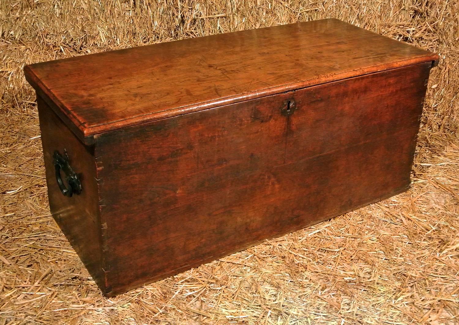 With a fabulous natural colour and good patination, a solid elm bed box c. 1690 with original rivetted iron strap hinges and attractive original iron carrying handles to sides.  Substantial dovetailed joints throughout.

Made to go at the end of a