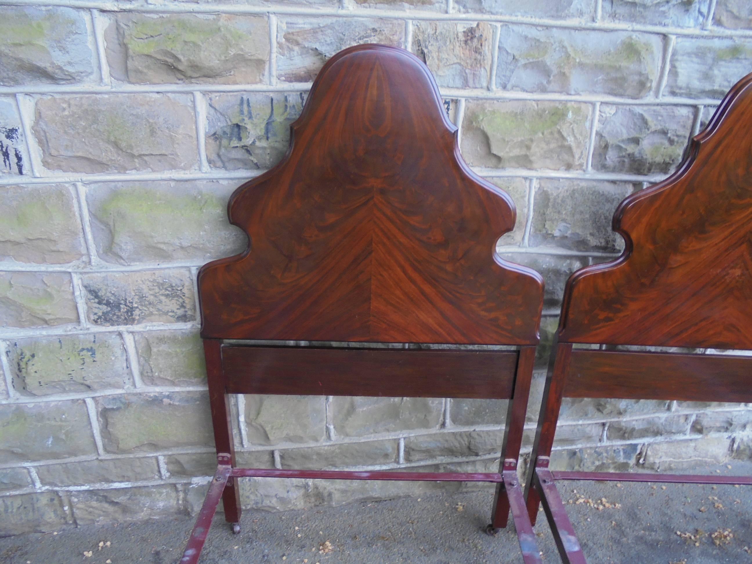 Offered for sale is this good quality pair of antique mahogany single beds

Dating from 1920. Made from solid mahogany. The headboard is a lovely shaped with arched top, and the footboard with scrolling cabriole legs. Really good quality timbers.