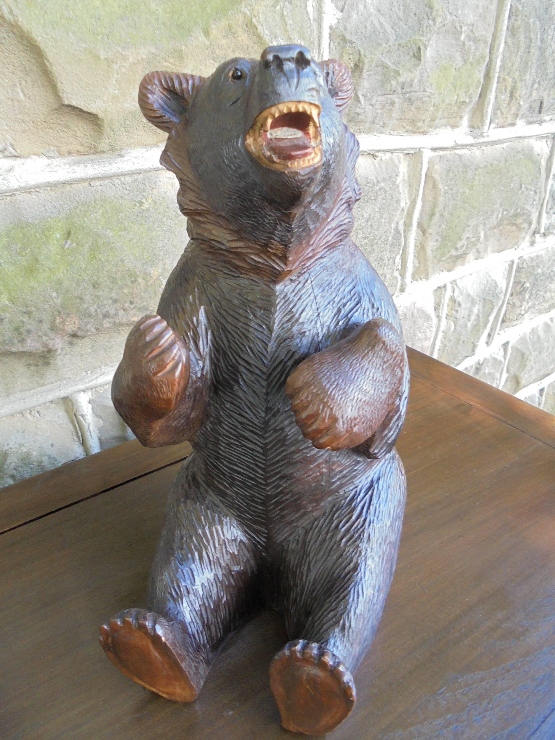 Offered for sale is this good sized antique carved Black Forest bear.

Well carved bear with good features, glass eyes. Nice original color and shine to the wood.

Offered in good original condition

Measures: Stands 15