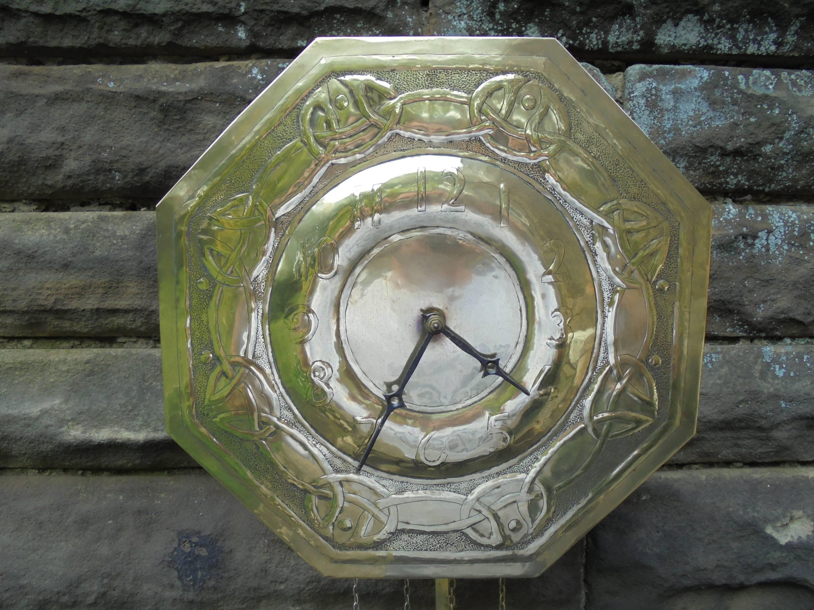 Offered for sale is this rare arts and crafts Glasgow school brass wall clock

Dating from 1900-1905. In the manner of Margaret Gilmour but unmarked. Brass dial with typical Celtic knot repousse decoration. Weight driven movement with the weights