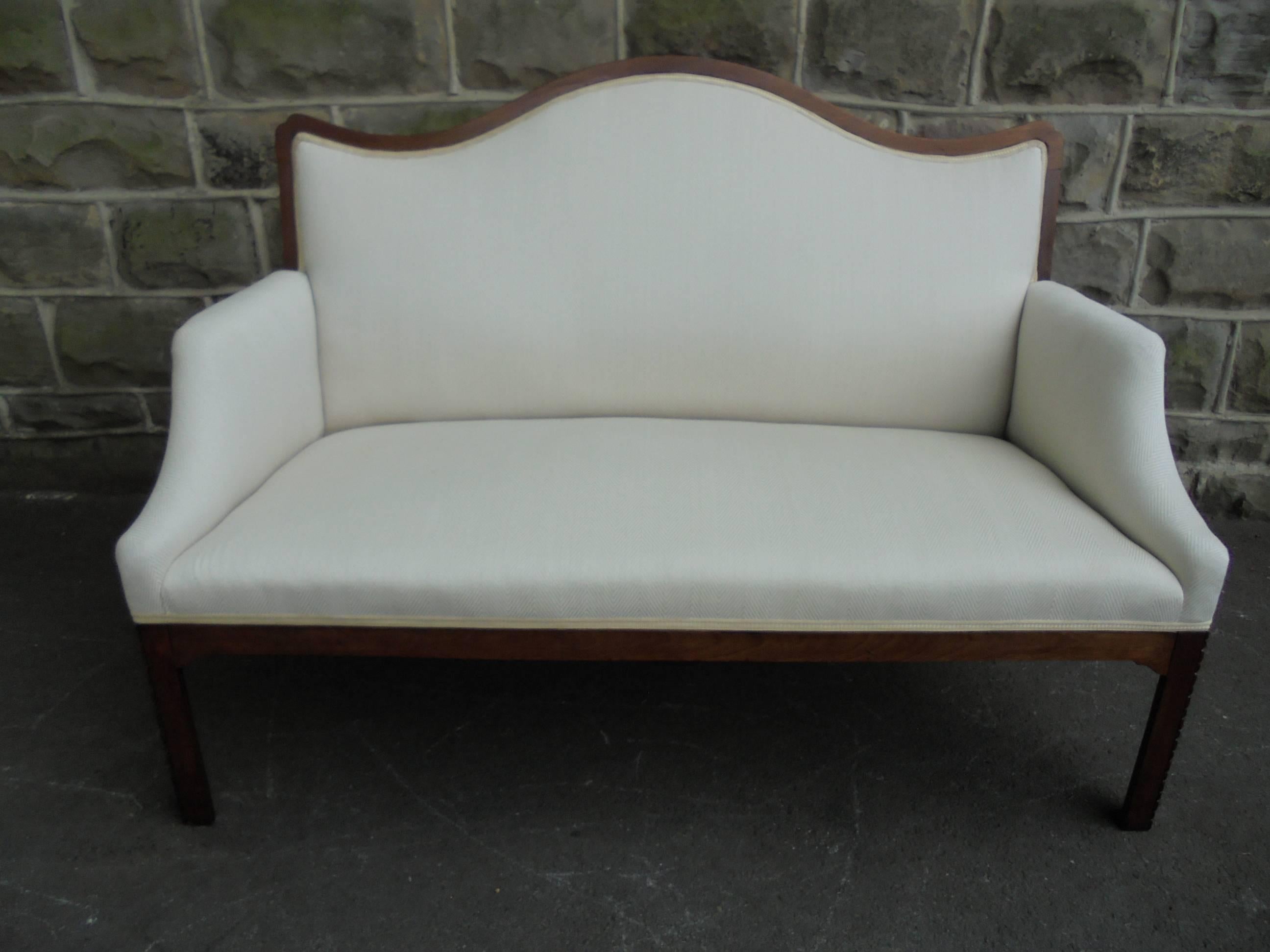 Offered for sale is this nice sized antique English upholstered sofa.

Dating from 1900. Mahogany frame having a shaped top rail, standing on square chamfered legs with carved decoration. Splayed legs to the back with castors (front legs have