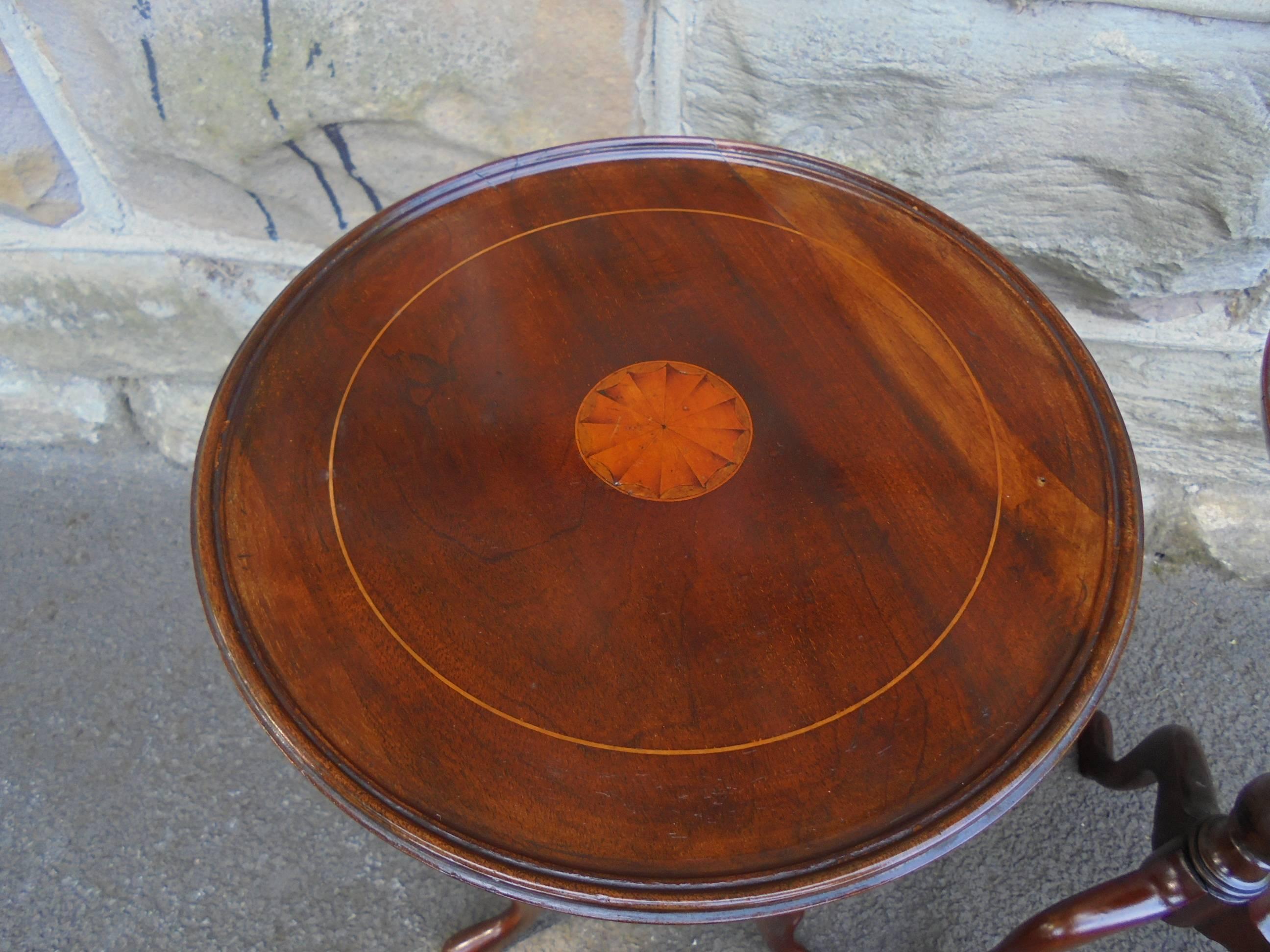 Offered for sale is this good quality pair of antique mahogany wine tables

Dating circa 1910. Round mahogany dished tops, with inlaid paterae to the centre. Turned column and three splayed legs.

Offered in good clean original condition. Good