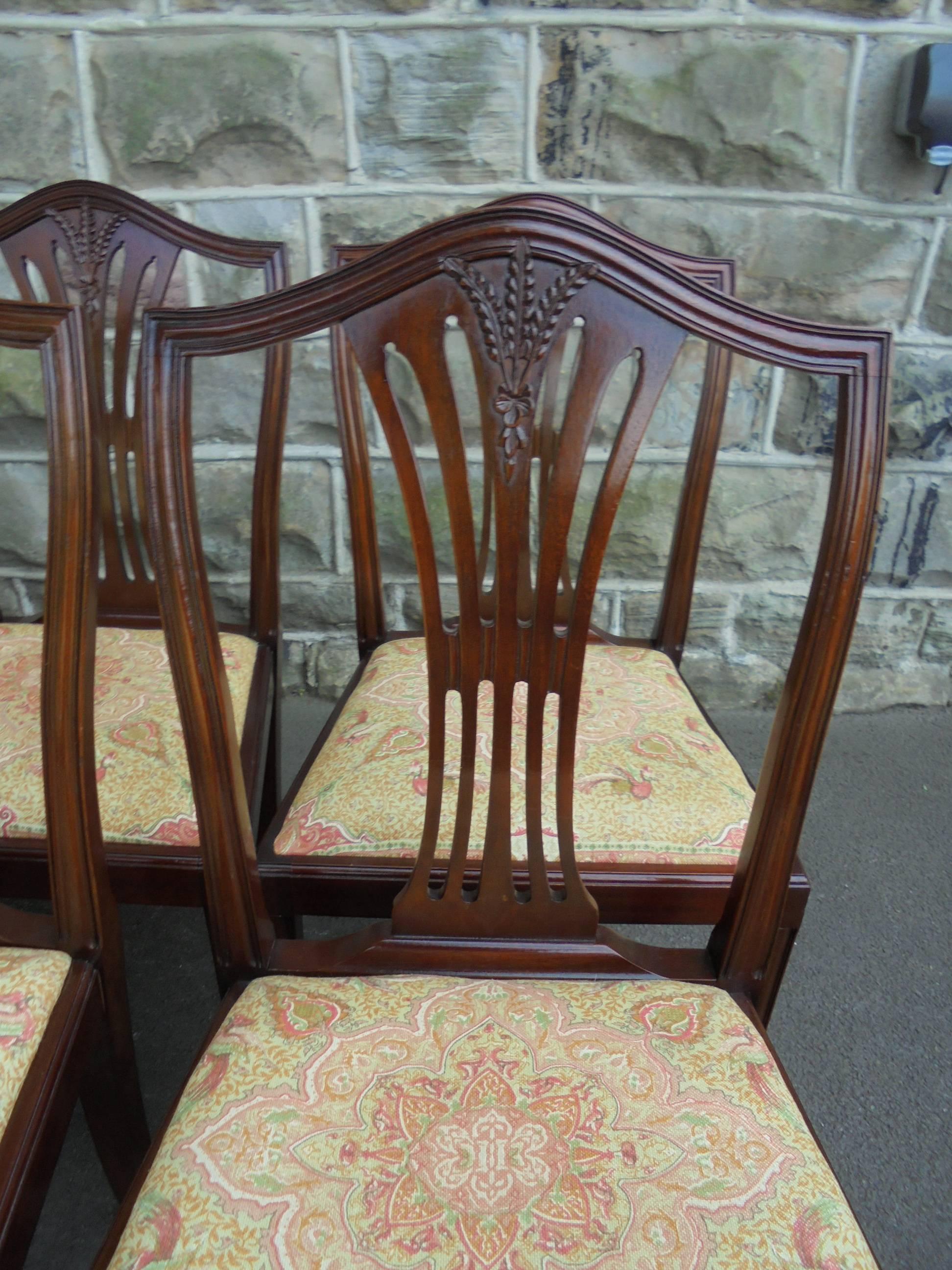 Offered for sale is this very good quality eight mahogany dining chairs. There are six singles and two carvers.

The chairs date from 1920 and are in the Hepplewhite style. All solid mahogany. Shaped top rails, pierced splat back with wheatsheaf