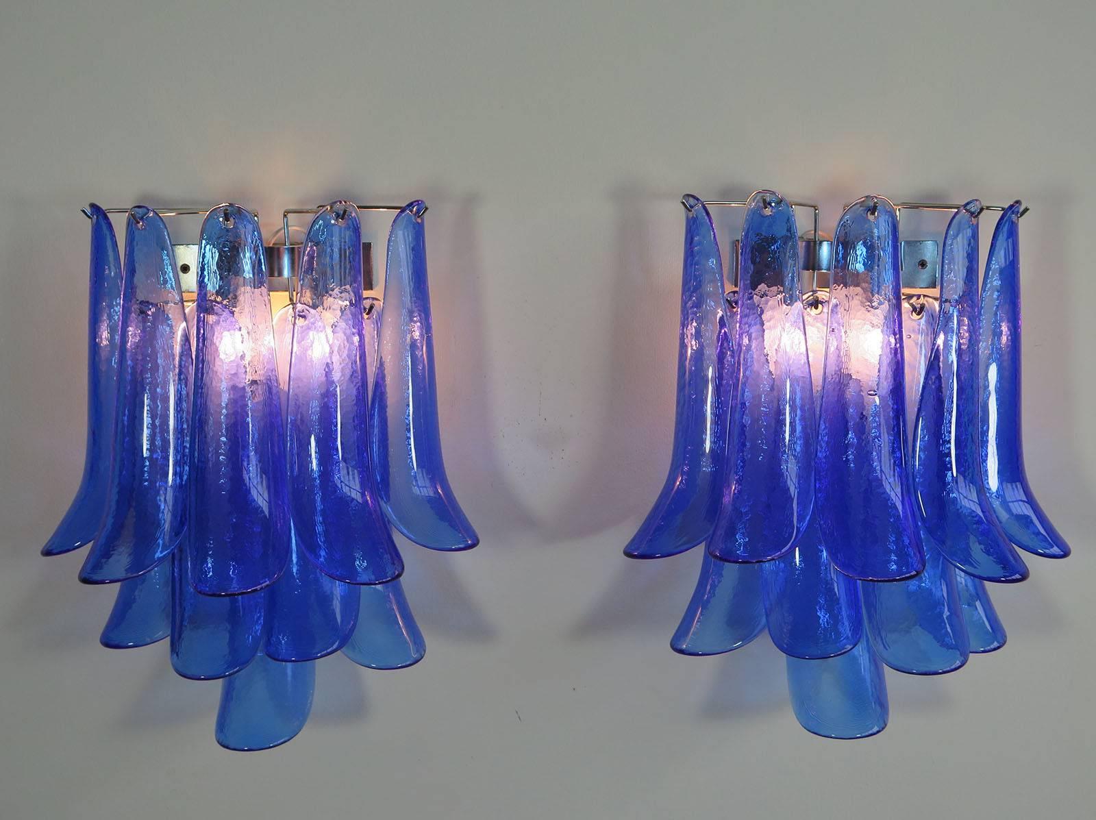 Pair of stunning Mazzega Italian Murano wall lights.

The lights have ten blue glass petals (for each applique) in a chrome frame and are in excellent condition, but the chrome has normal signs of wear and tear due to his age.

Light bulbs: