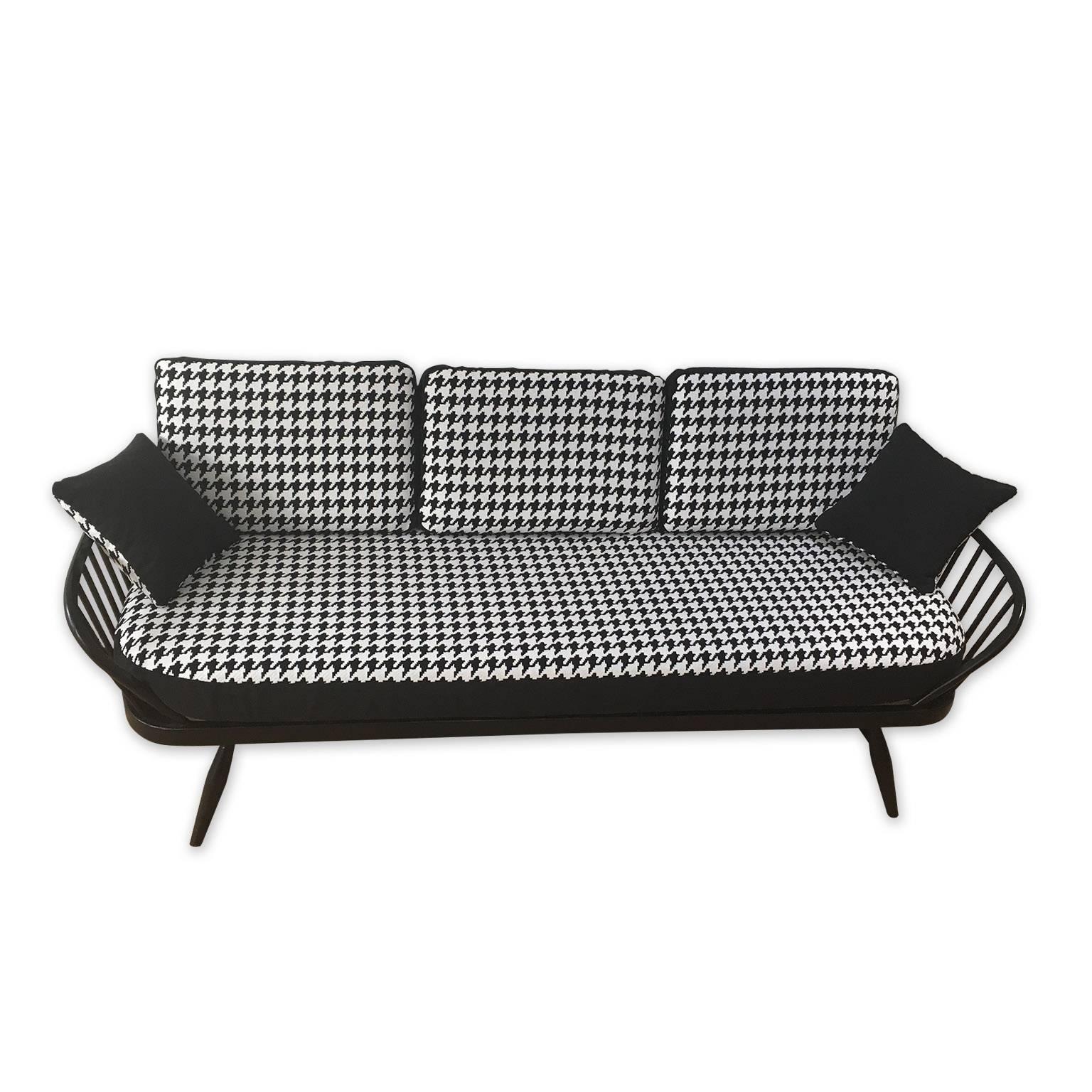 Vintage Ercol studio couch lovingly refurbished and upholstered in a black and white check Warwick fabric. The cover is reversible for an all-black look.
 
The Ercol couch itself has been re-sprayed in a black satin paint finish and furnished with