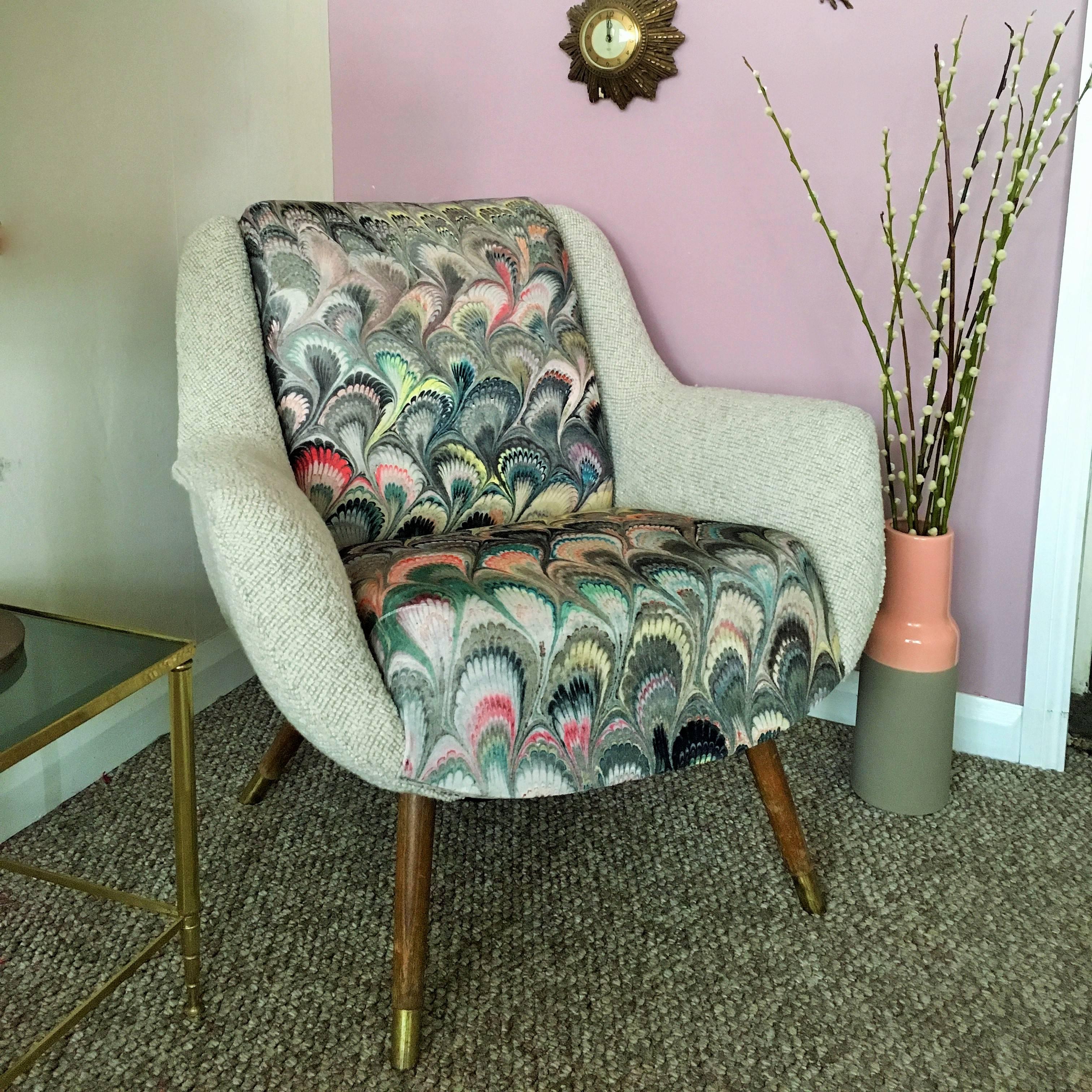 Vintage Danish tub chair professionally re-upholstered in a light grey bouclé fabric on the arms, with the back and seat covered in a unique marbleized fabric by interior designer Beata Heuman.
 
The chair is finished with wooden legs with brass