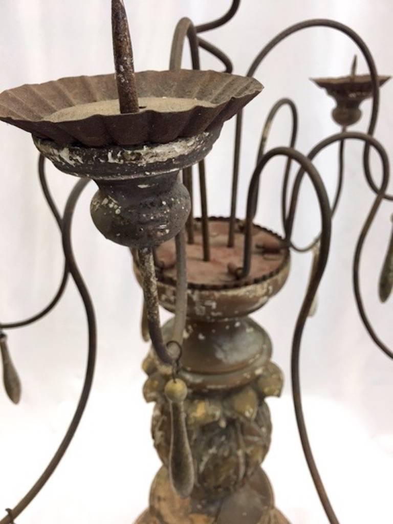 This pair of impressive candelabra has been re-worked this century with the addition of the iron armatures. The balustrade bases are original and weathered beautifully. Beyond shabby chic, they add some old world glamour to the contemporary setting