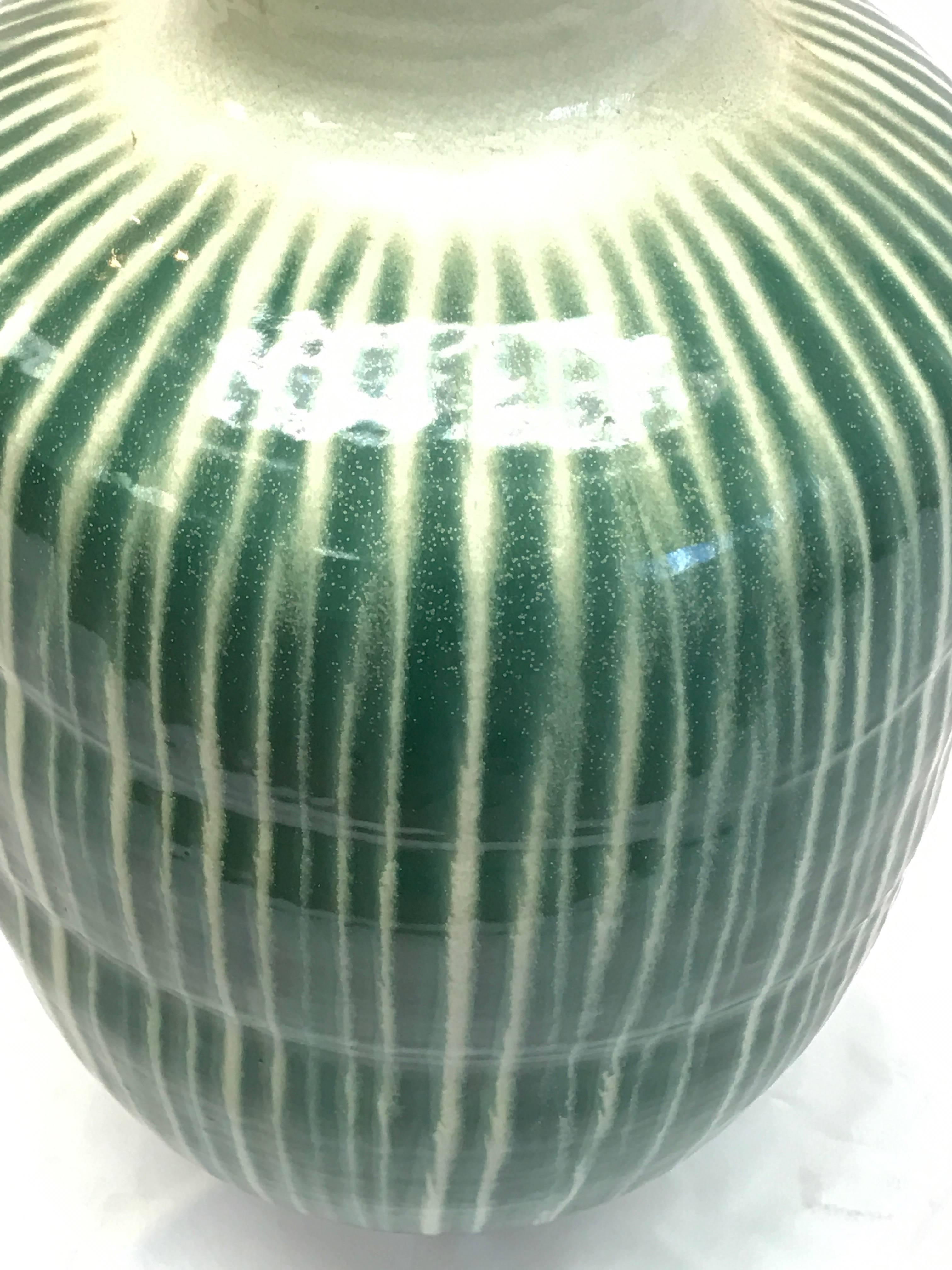 This Shigaraki kiln fired storage jar is striped in jade green which evokes the Japanese tradition of nature and balance. The unusual proportions of this very large vase demand attention as well as respect for heritage.