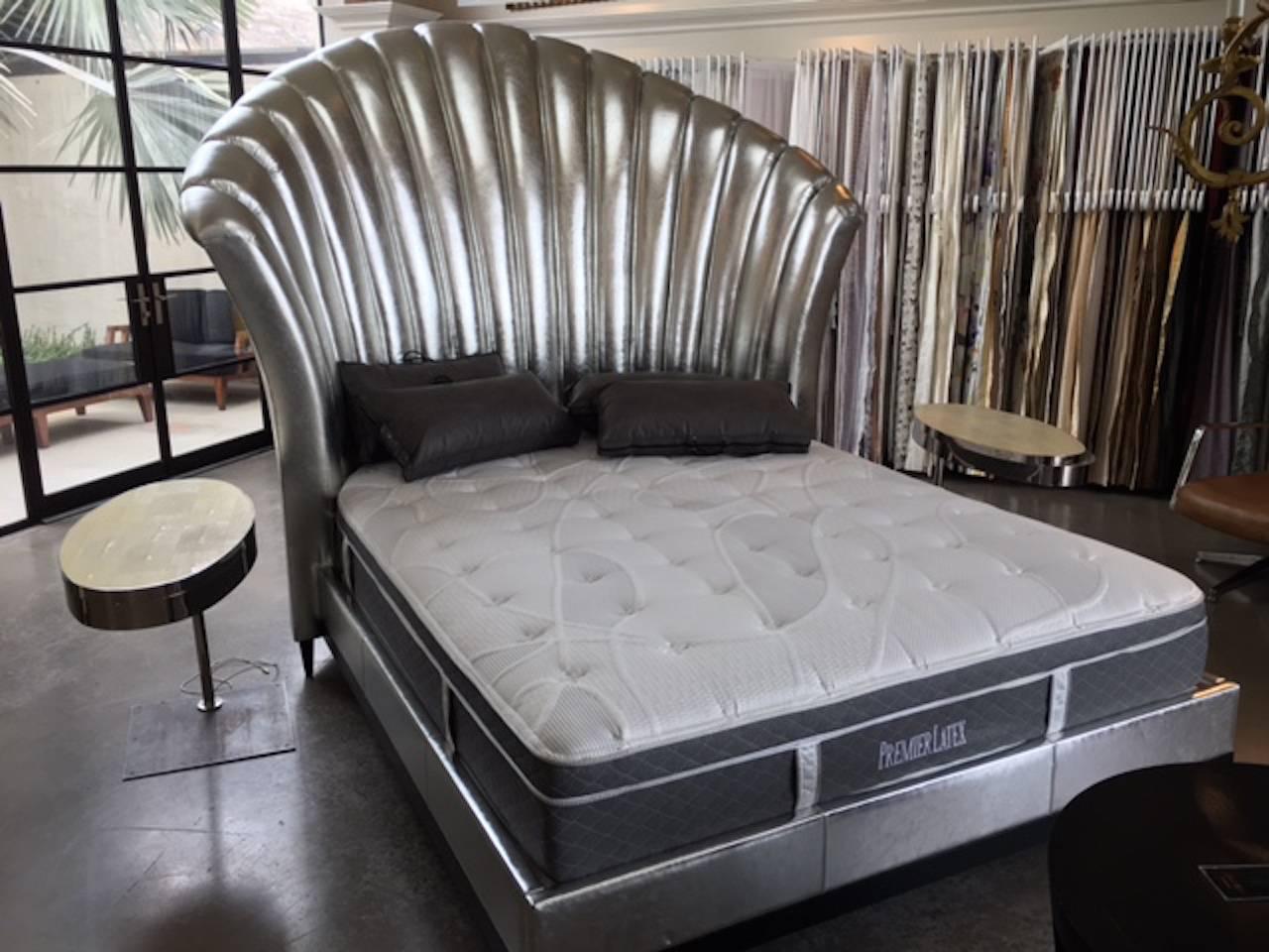 This imposing bed is upholstered in silver Italian leather on an ebonized wood base that supports the silver leather surround for the box spring. The dimensions are derived from Hollywood booths where you could sit comfortably. Thank you Mommie