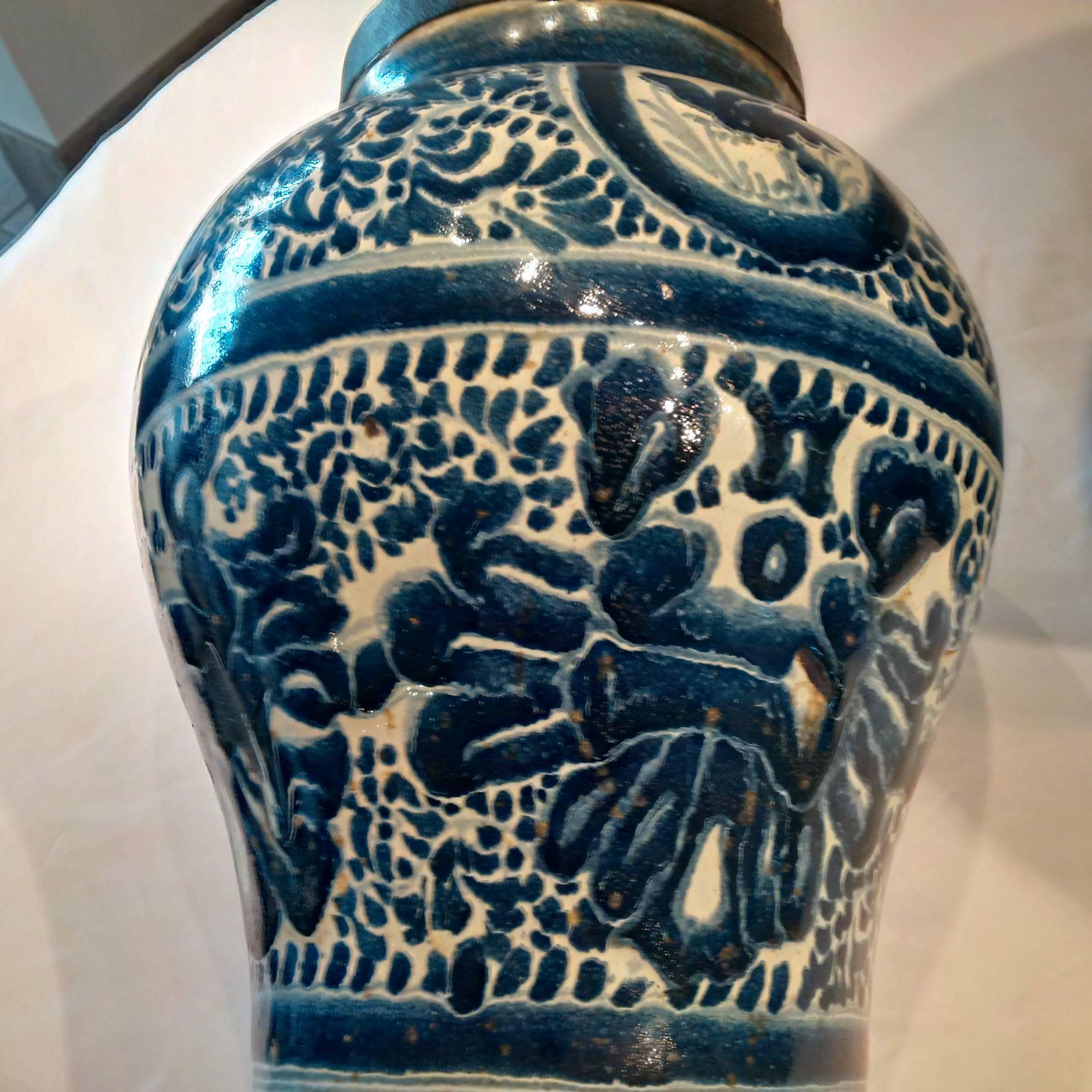 The Talavera is produced in Puebla Mexico and the oldest factory there says the design is Chinese phoenix. These jars were locked to secure the spices, especially chocolate. The signature on the bottom suggests that it was the anagram of the person