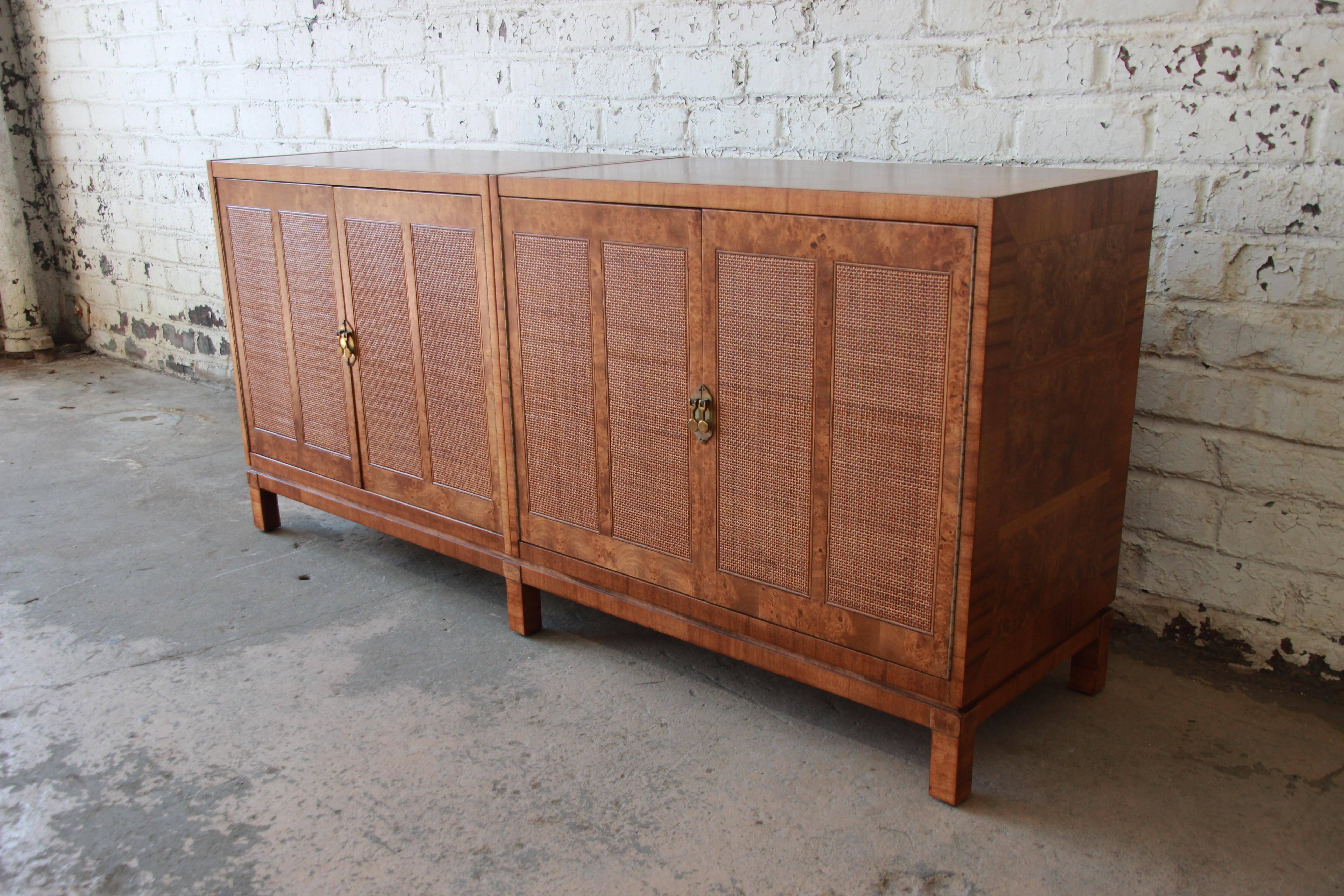 Exceptional Mid-Century Modern burled amboyna credenza or sideboard designed by Bernhard Rohne for Mastercraft. The credenza features stunning burled wood grain, sleek Mid-Century design, and woven front doors. It offers ample room for storage, with