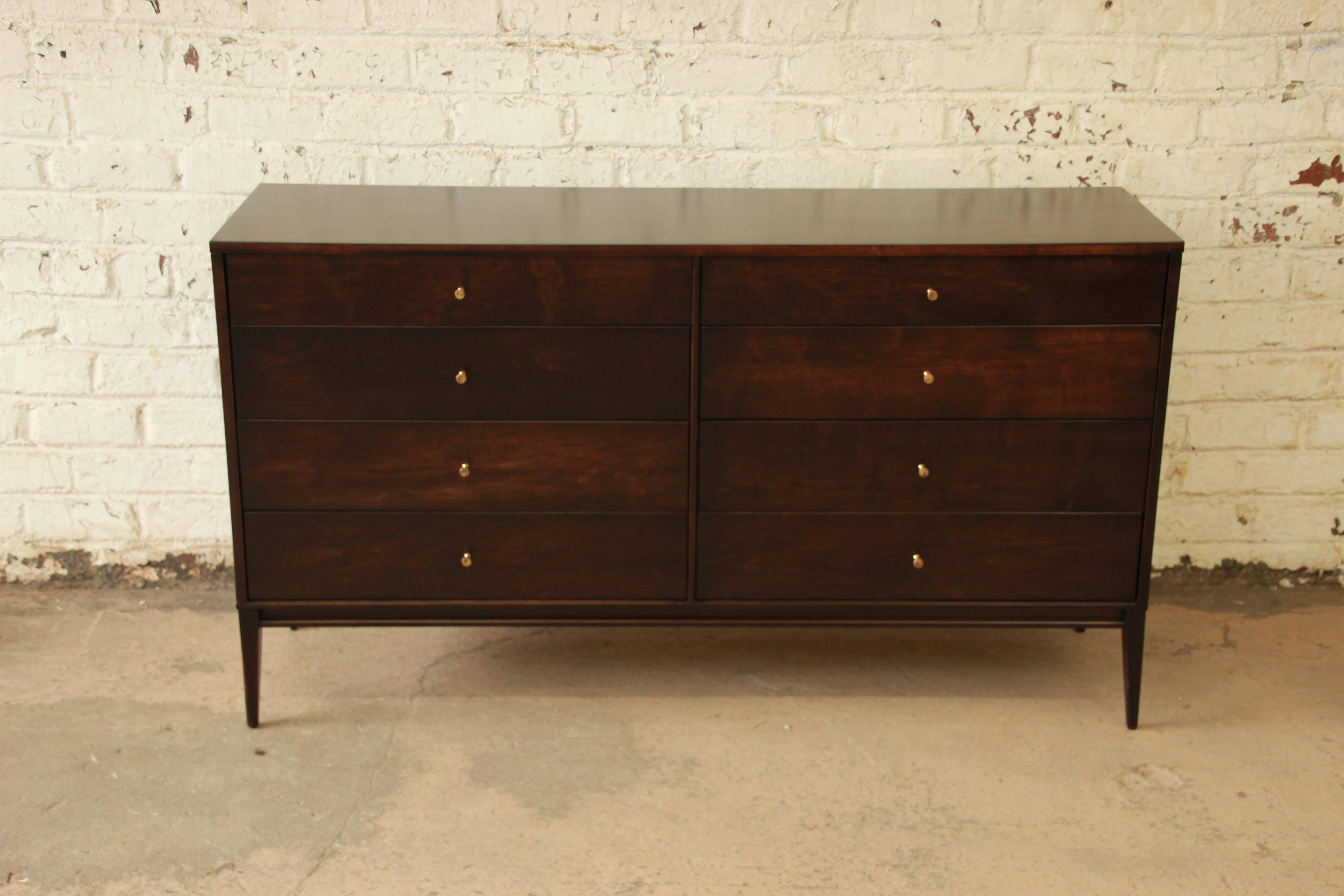 Eight-drawer dresser or credenza designed by Paul McCobb for the iconic Planner Group by Winchendon. The dresser features exceptional solid wood construction and a body raised on slim, tapered legs. The solid maple piece has been refinished in a