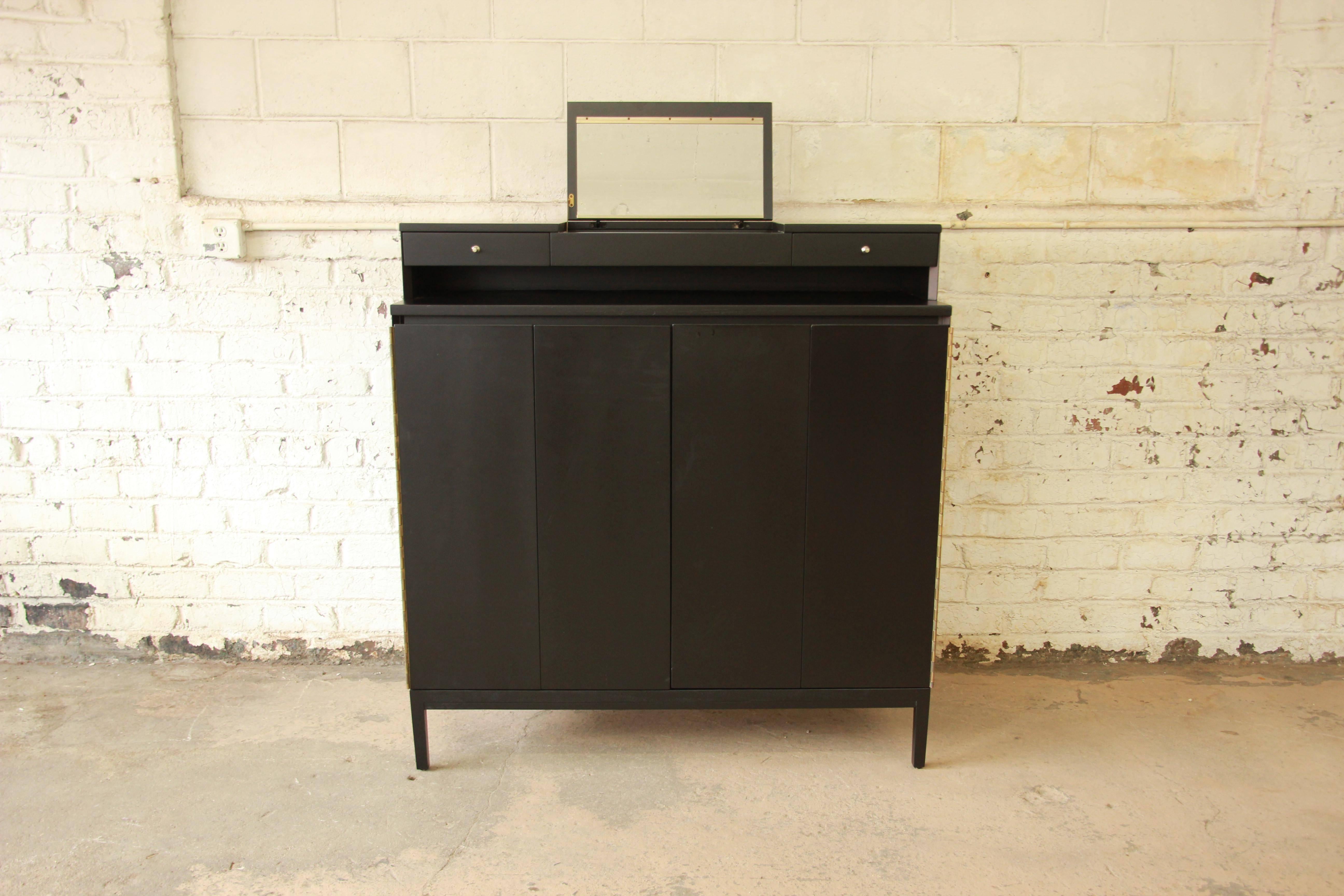 An exceptional Mid-Century Modern black lacquered walnut gentleman's chest, designed by Paul McCobb for Calvin Furniture's 