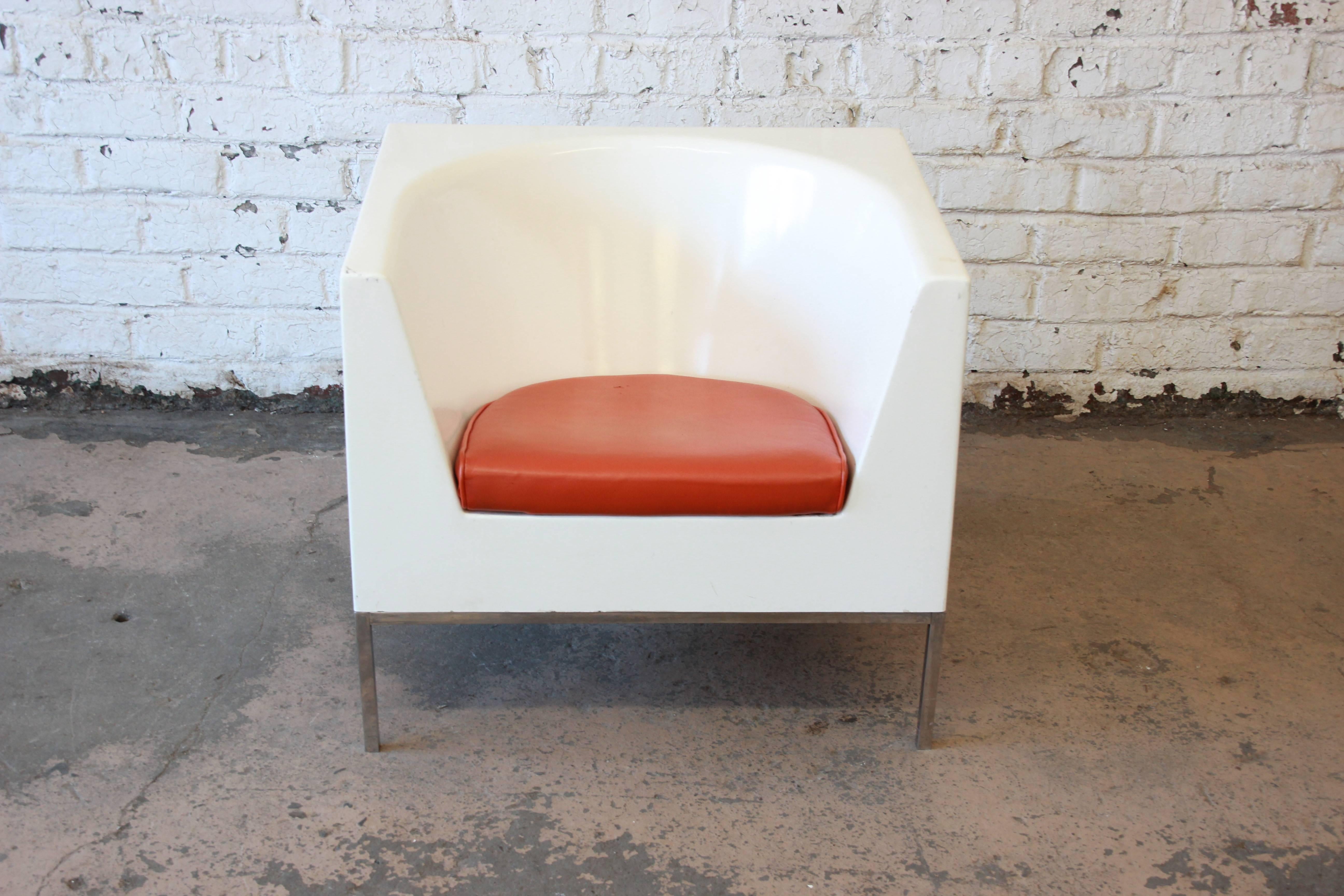 Offering a nice Massimo Vignelli style cube chair with orange upholstered cushion. The white molded cube chair rests on a framed chrome base with square legs. It is in overall good condition with appropriate wear from age and use.