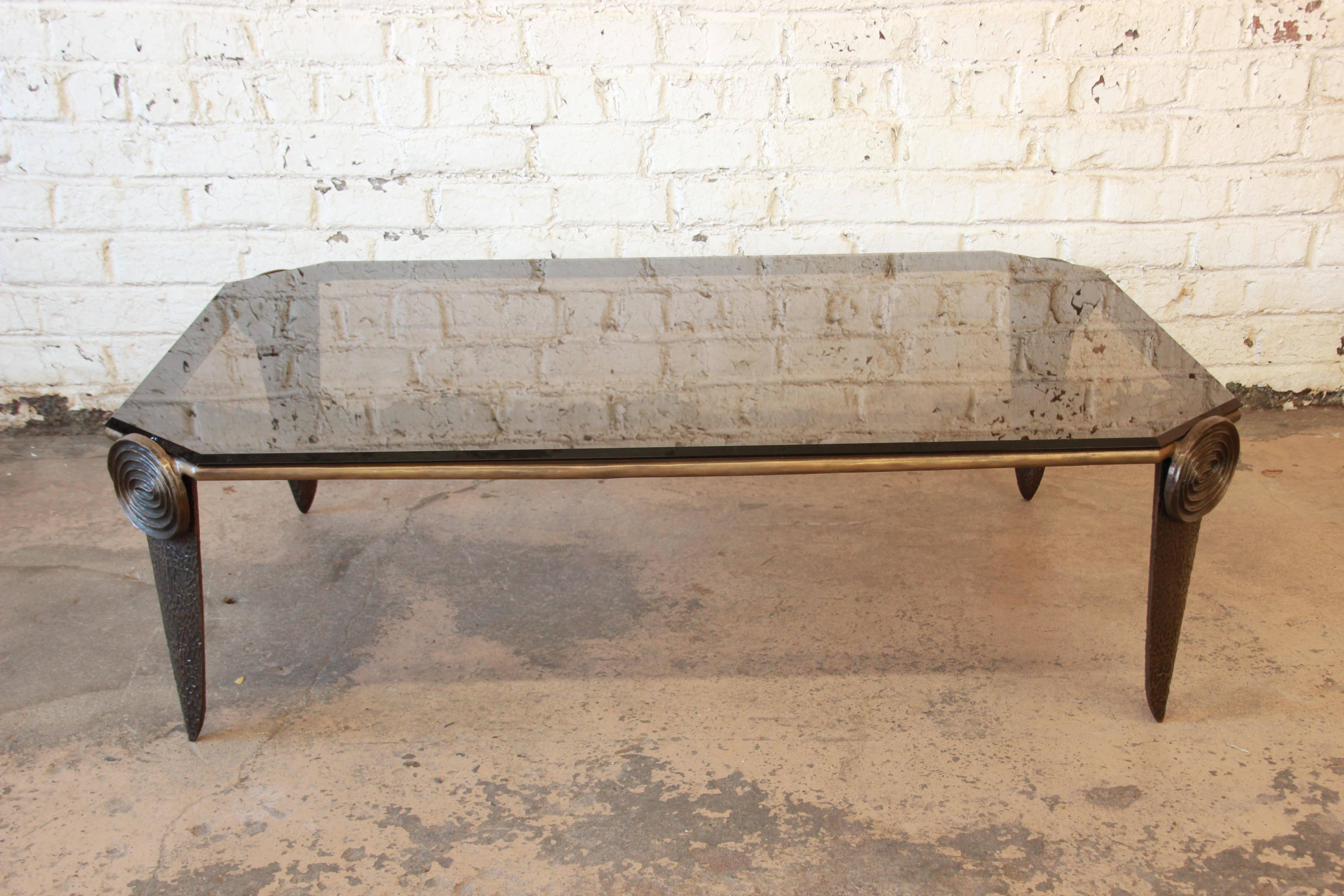 Exceptional and large Brutalist style coffee table in the manner of Adrian Pearsall. The table features a unique modern design on the cast solid bronze base and a beautiful beveled smoked glass table top.

A foundry mark is present on the bottom