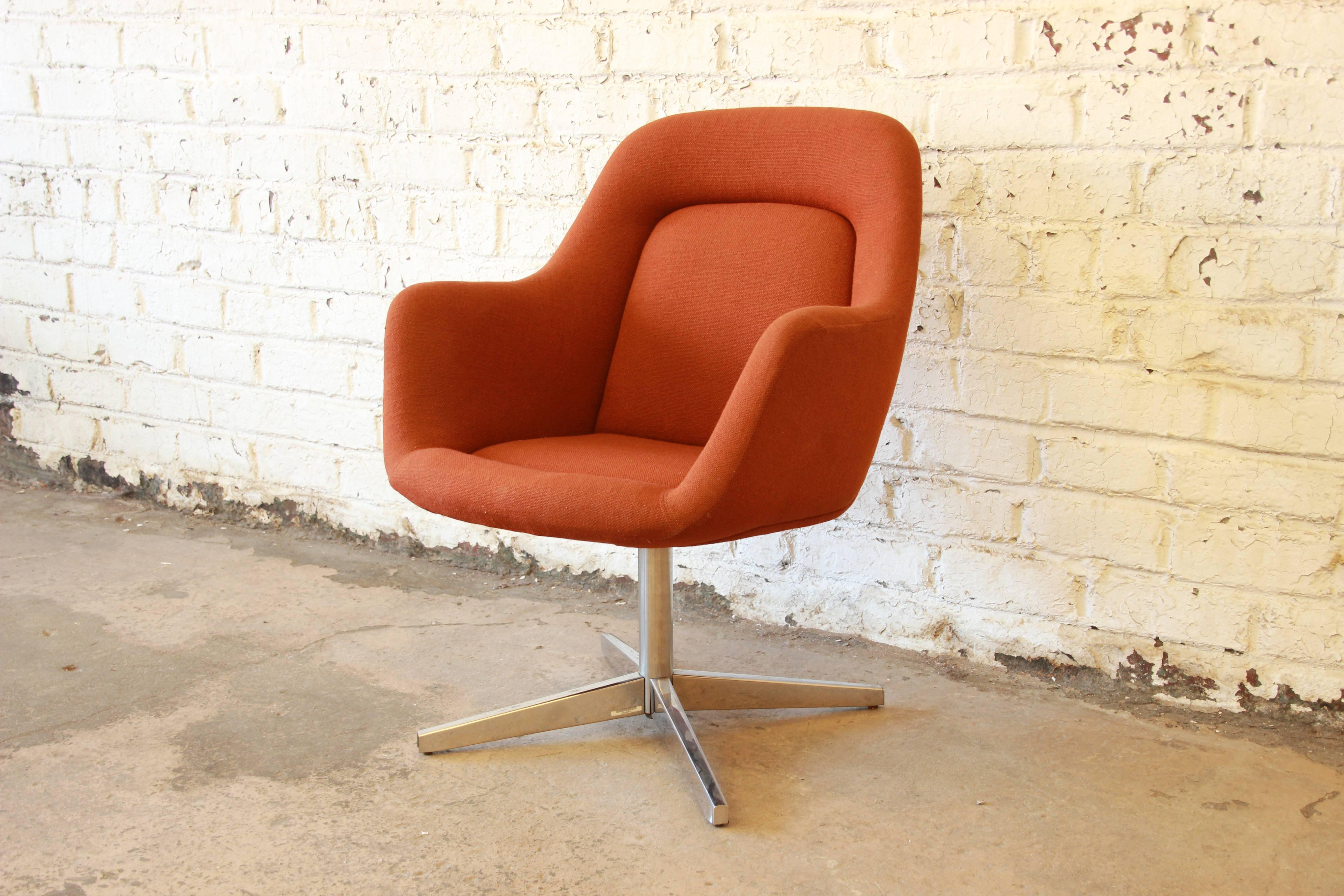 A very nice swiveling club or office chair designed by Max Pearson for Knoll International. The chair features a polished chrome base and original orange upholstery in very good condition. There is one very small spot of wear (see picture). Original