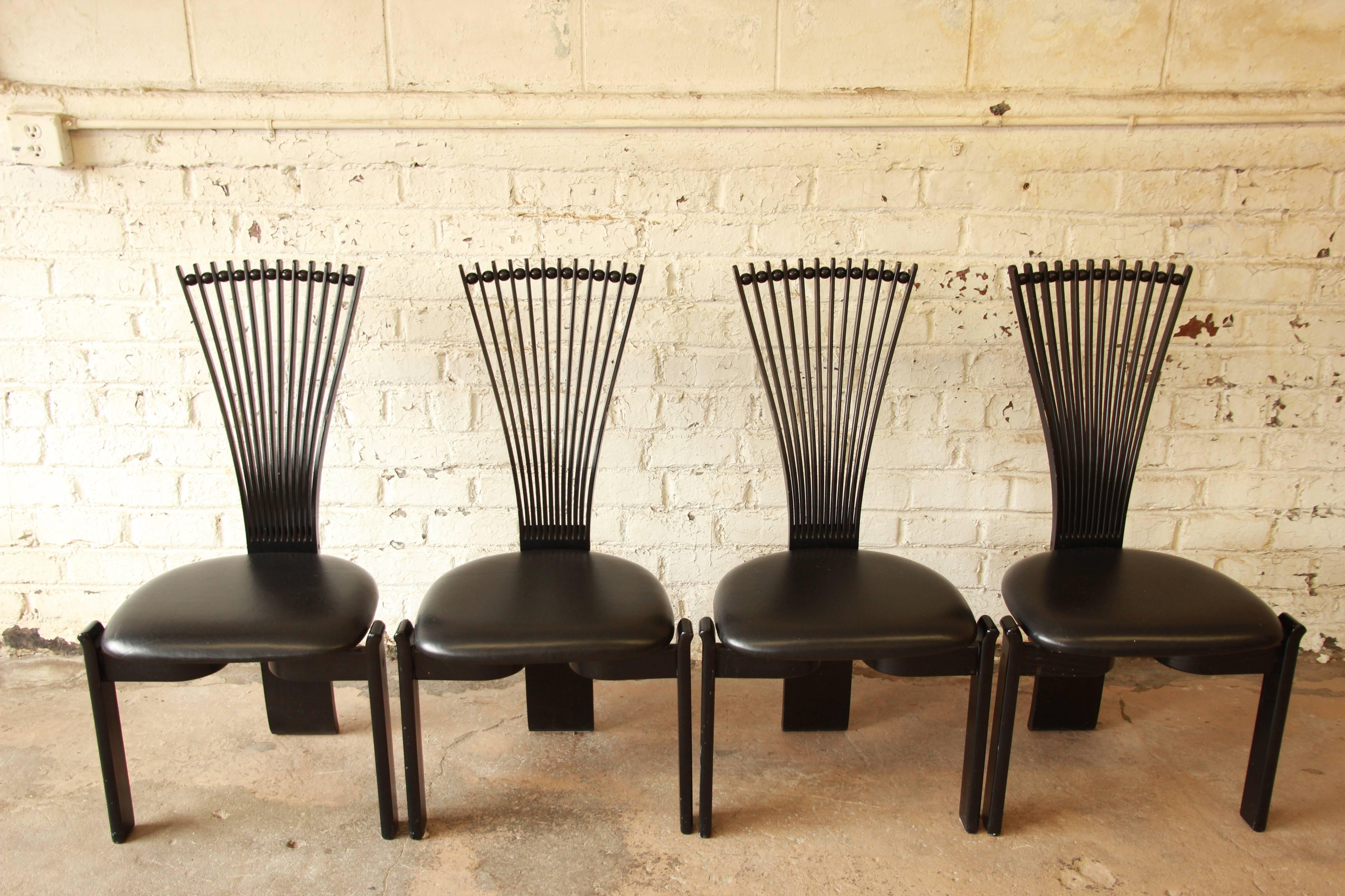 A very unique set of four Mid-Century Scandinavian Modern black lacquered fan back dining chairs by Torstein Nilsen for Westnofa. The chairs feature solid teak and oakwood stick and ball, fan back, frames, curved stretchers, and beautiful sculptural