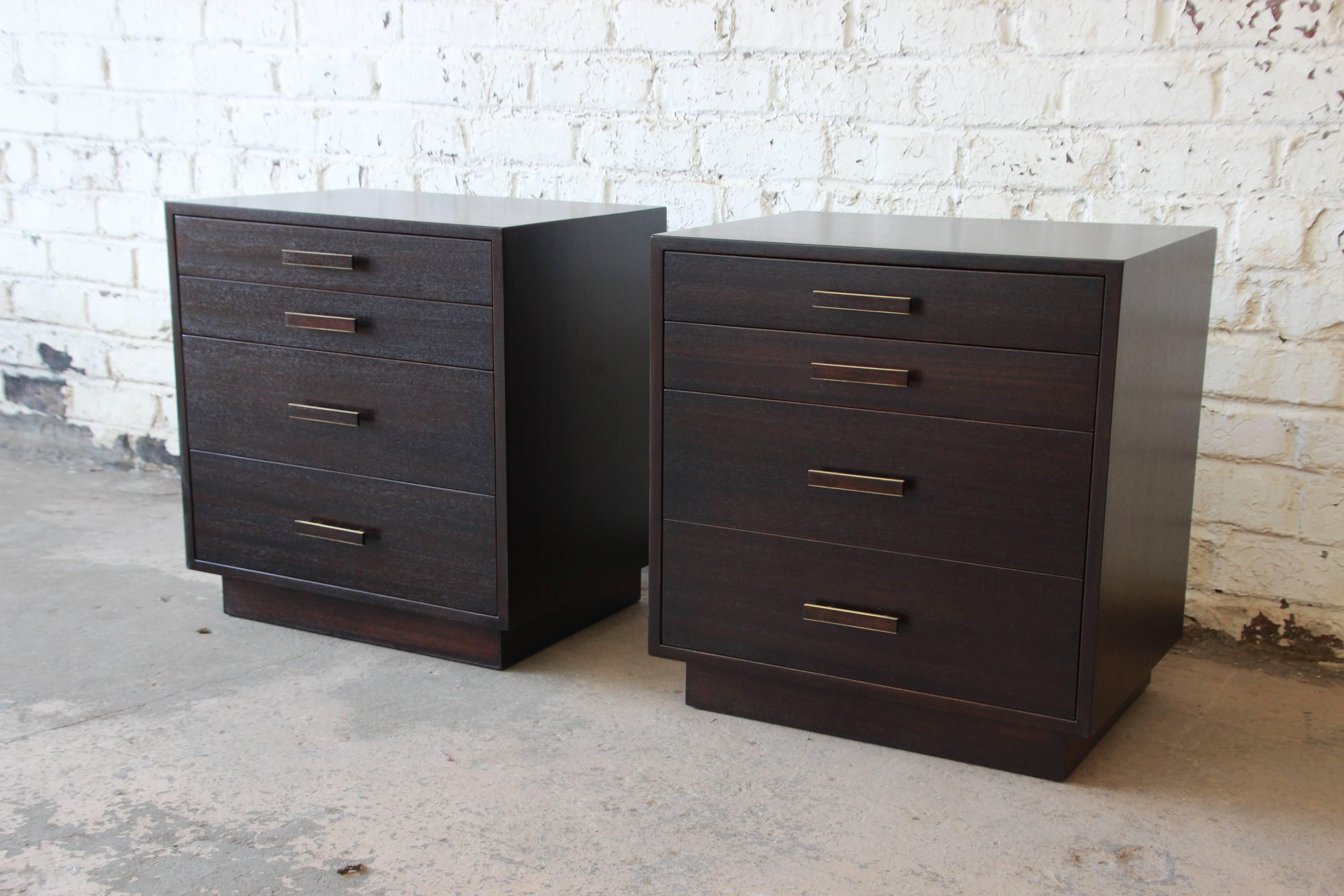 An excellent pair of chest or nightstands by Harvey Probber. The nightstands have been restored and refinished into a dark mahogany finish. The top two drawers are smaller with two larger drawers at the bottom. The brass pulls are fitted with