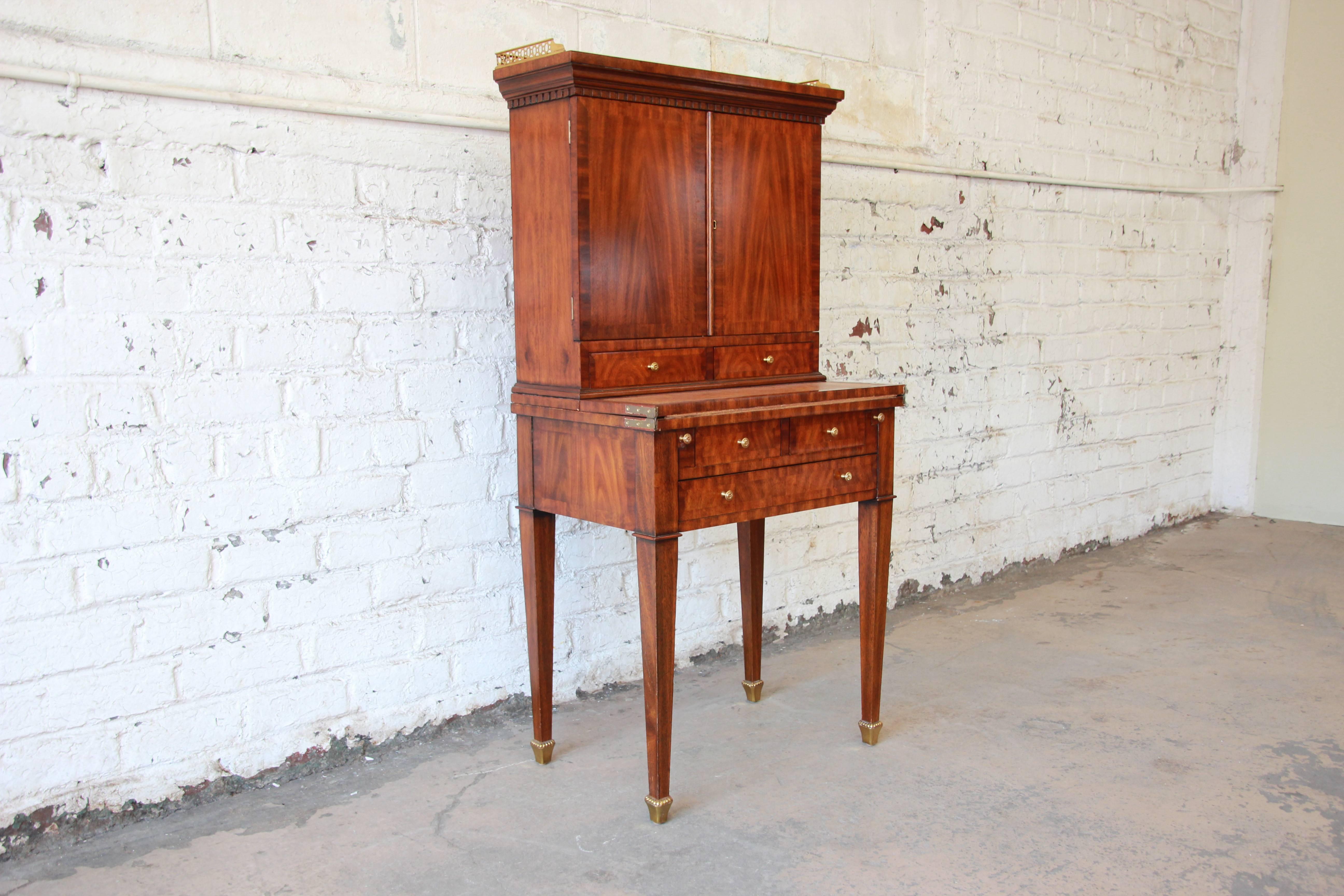 Offering a beautiful secretary desk by Maitland Smith. The desk is made from satinwood veneers. The writing desk flips out for a nice adequate writing space or room for a laptop. Below are two drawers for storage. Behind the leather top writing