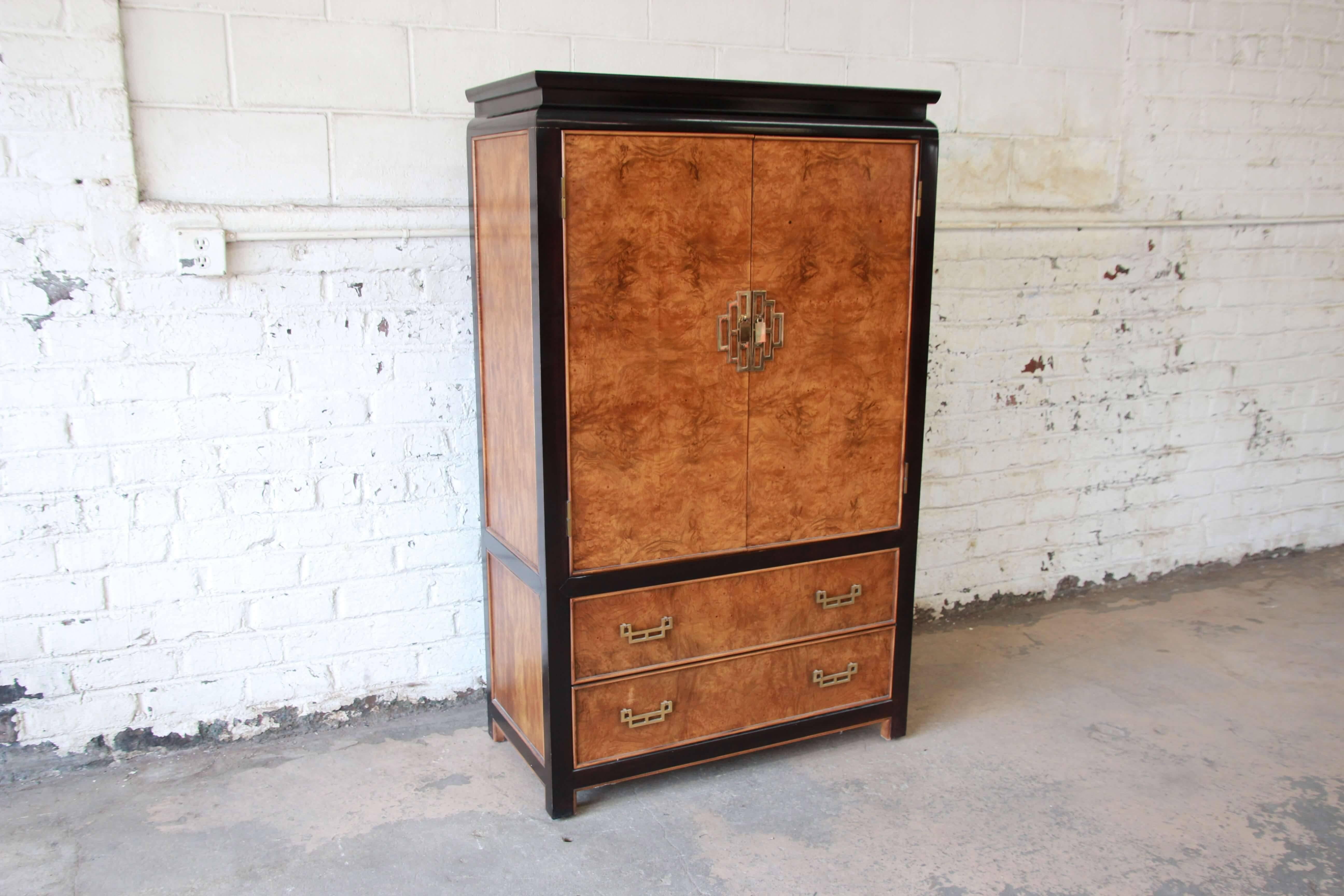 Offering a beautiful burl wood and black lacquered gentlemen's chests from the Chin Hua line from Century Furniture Co. The chest has a stunning burl wood finish outlined in a black lacquer and brass hardware. The chest's two cabinet doors open up