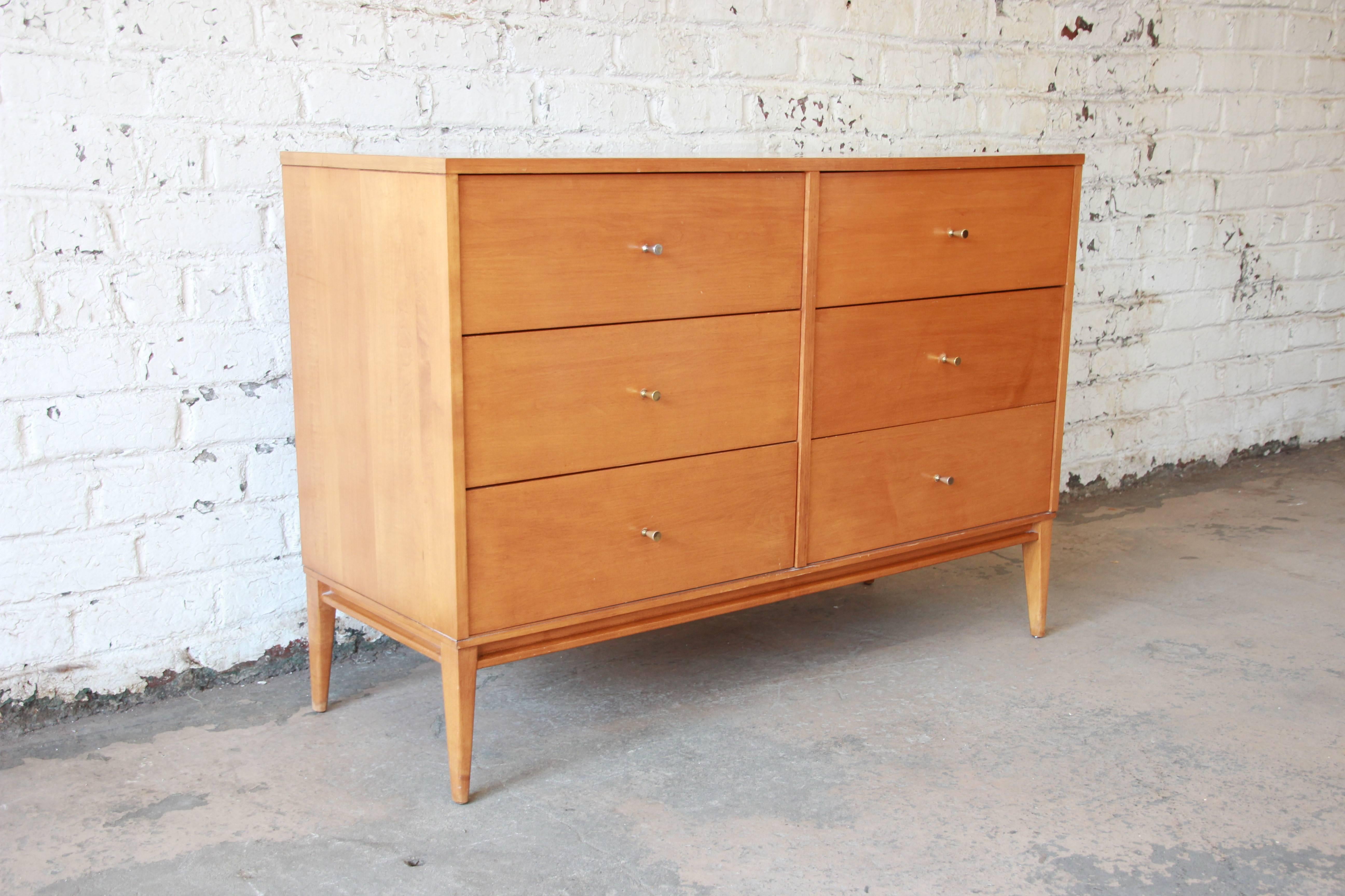 Offering a beautiful original Paul McCobb six-drawer dresser. The dresser is in great original condition with brass pulls. The drawers open and close smoothly and is made from solid birch. This iconic dresser was designed by Paul McCobb for