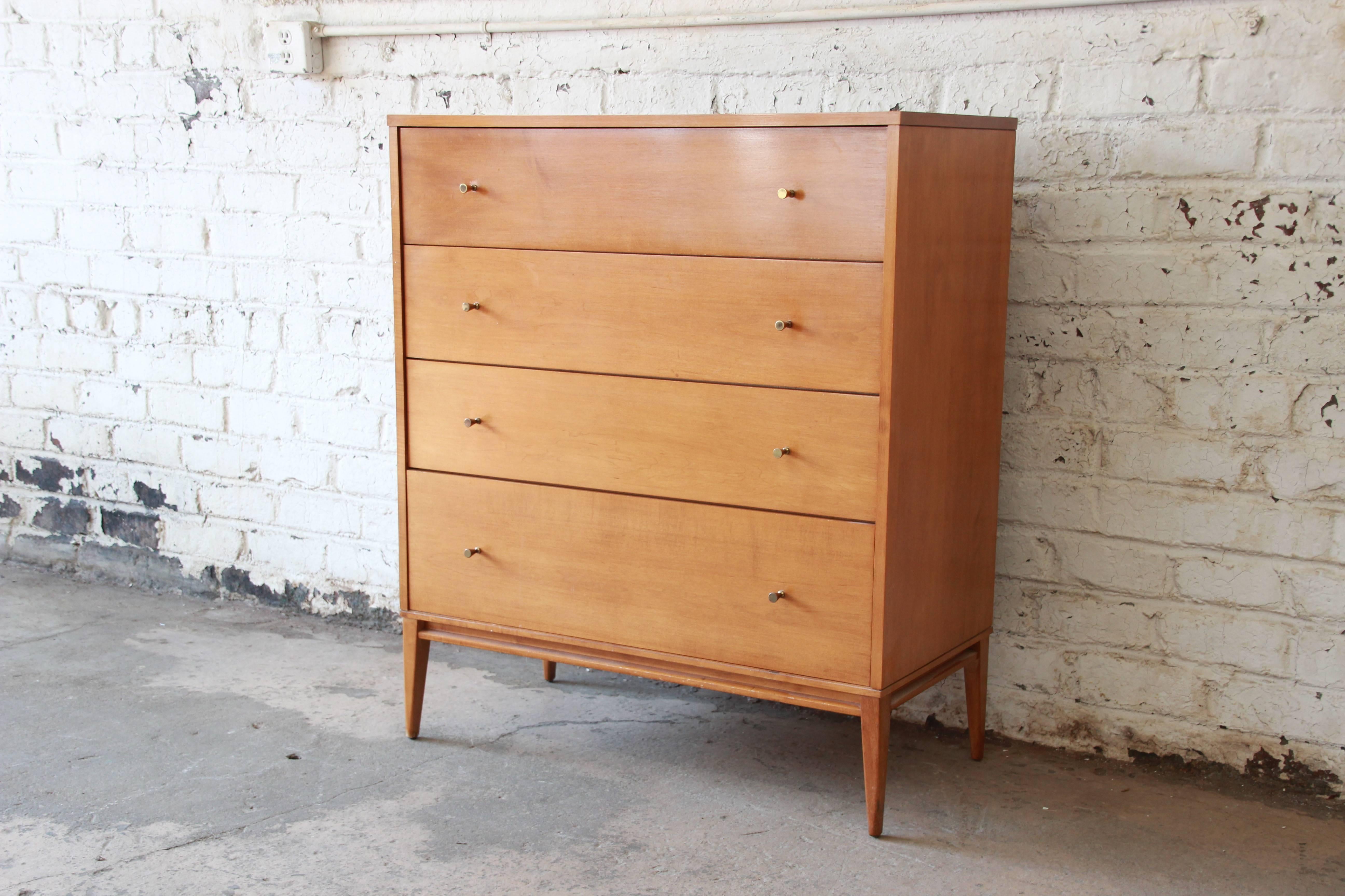 Offering a rare and fantastic Paul McCobb Planner Group highboy dresser. The dresser features four large drawers that open and close smoothly and provide lots of room for storage. The highboy is made from solid birch and has the original finish. The