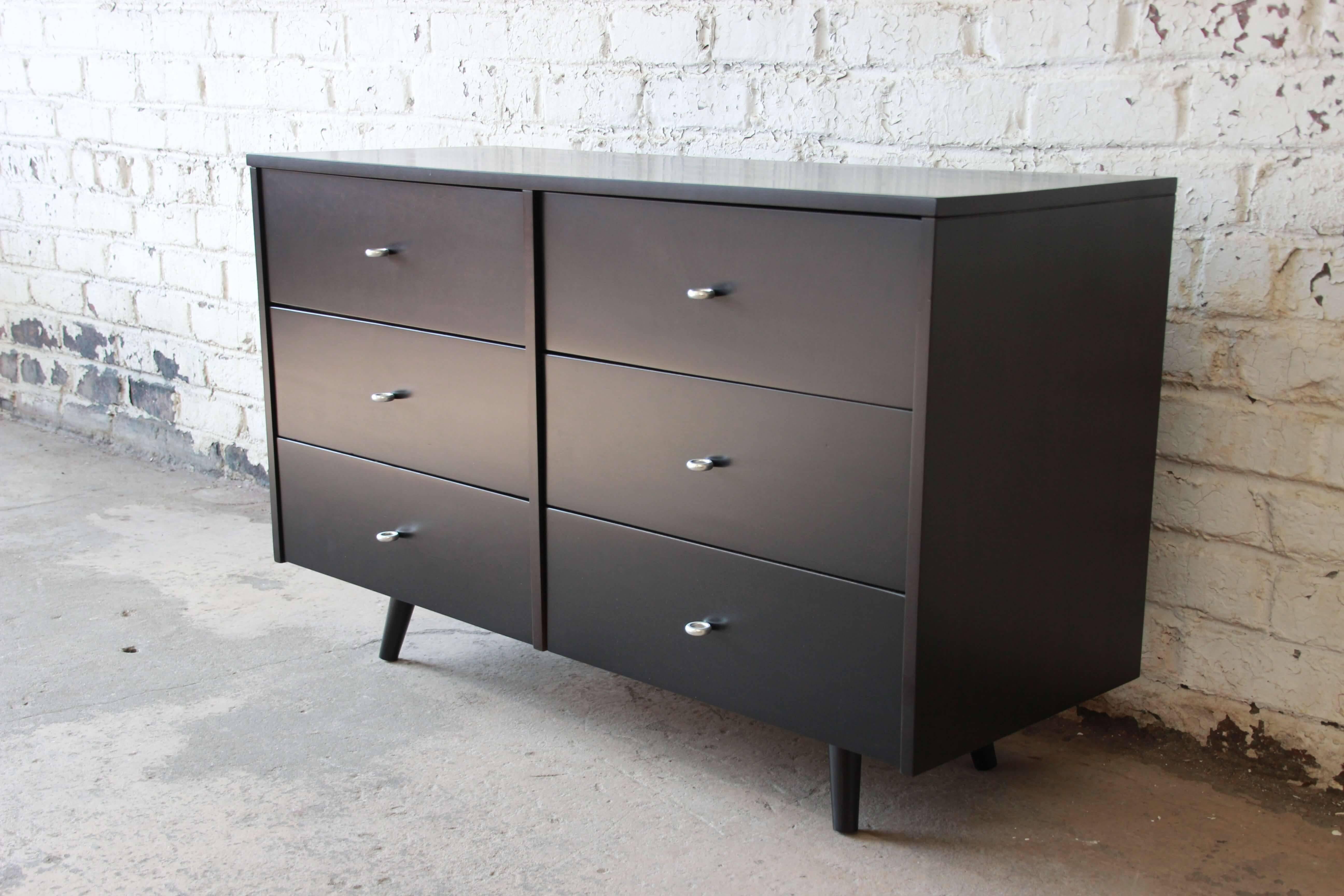 Offering a beautiful Mid-Century Modern ebonized six-drawer dresser designed by Paul McCobb for his iconic Planner Group line for Winchendon Furniture. The dresser features solid birch construction and original McCobb aluminum ring drawer pulls. The