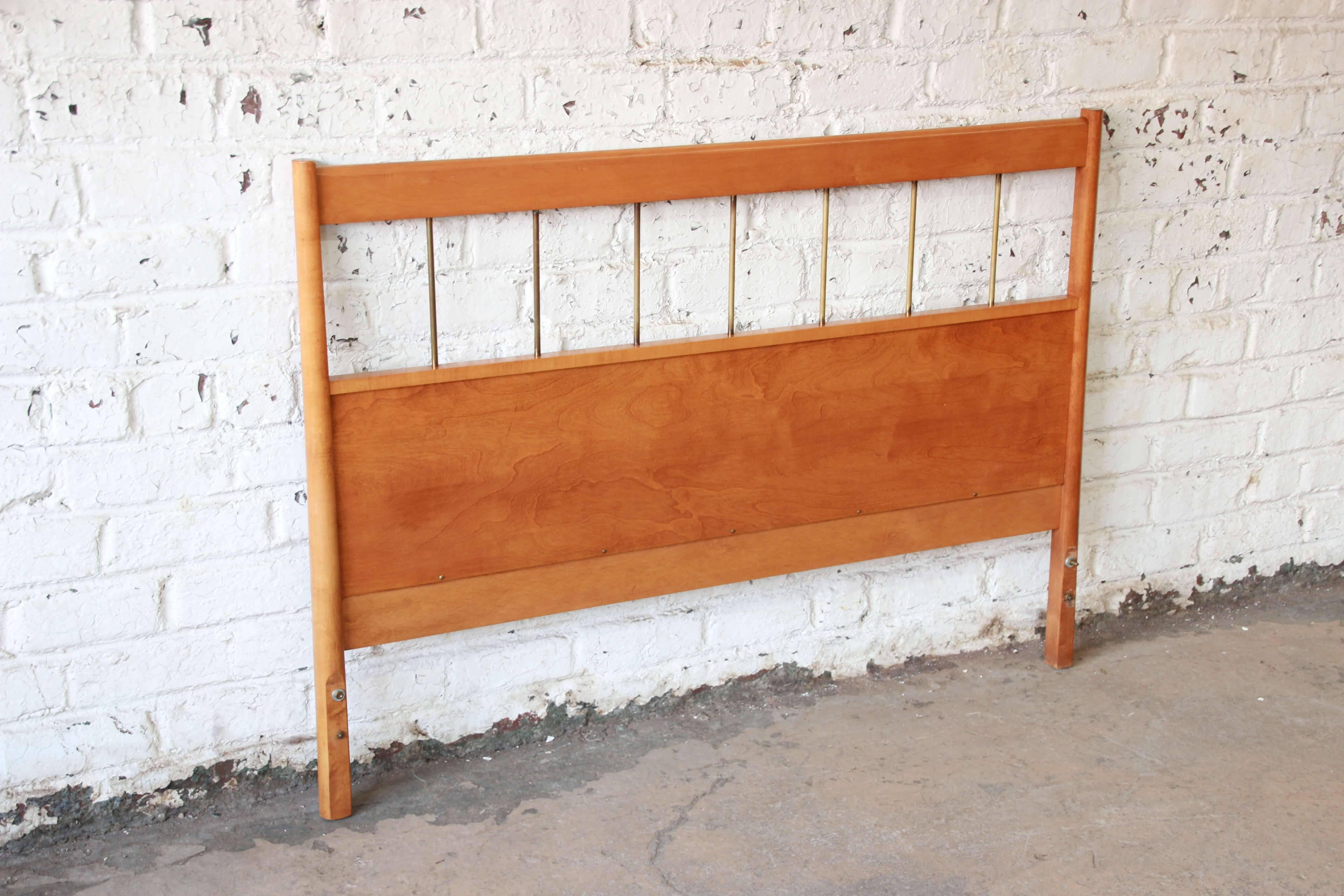Offering a rare full size headboard designed by Paul McCobb for his iconic Planner Group line for Winchendon Furniture. The headboard feature stunning wood grain and brass spindles. It is made from solid birch and in excellent vintage condition.