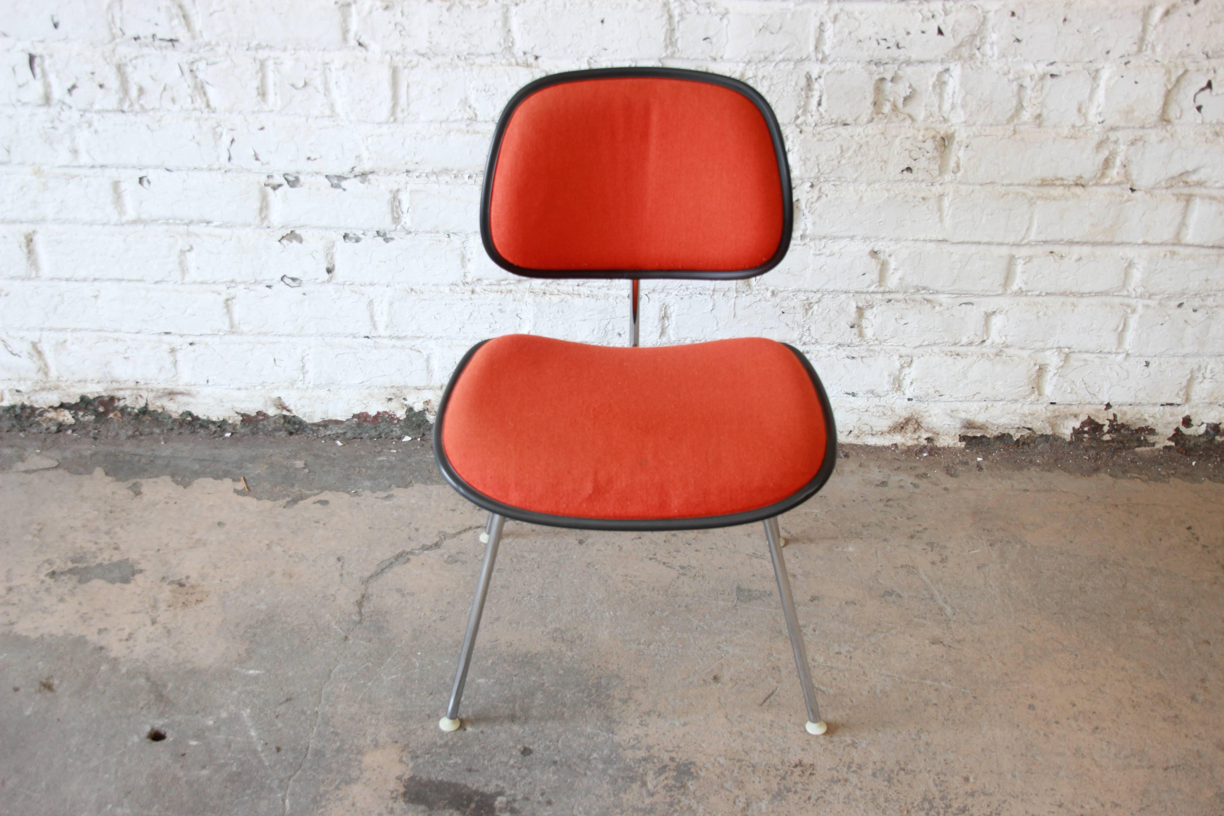 A very nice EC-127 DCM side chair designed by Charles and Ray Eames for Herman Miller, circa 1971-1981. Featuring molded plastic seats and backs with handsome orange wool upholstery. Legs and frame are solid chrome-plated steel. Original Herman