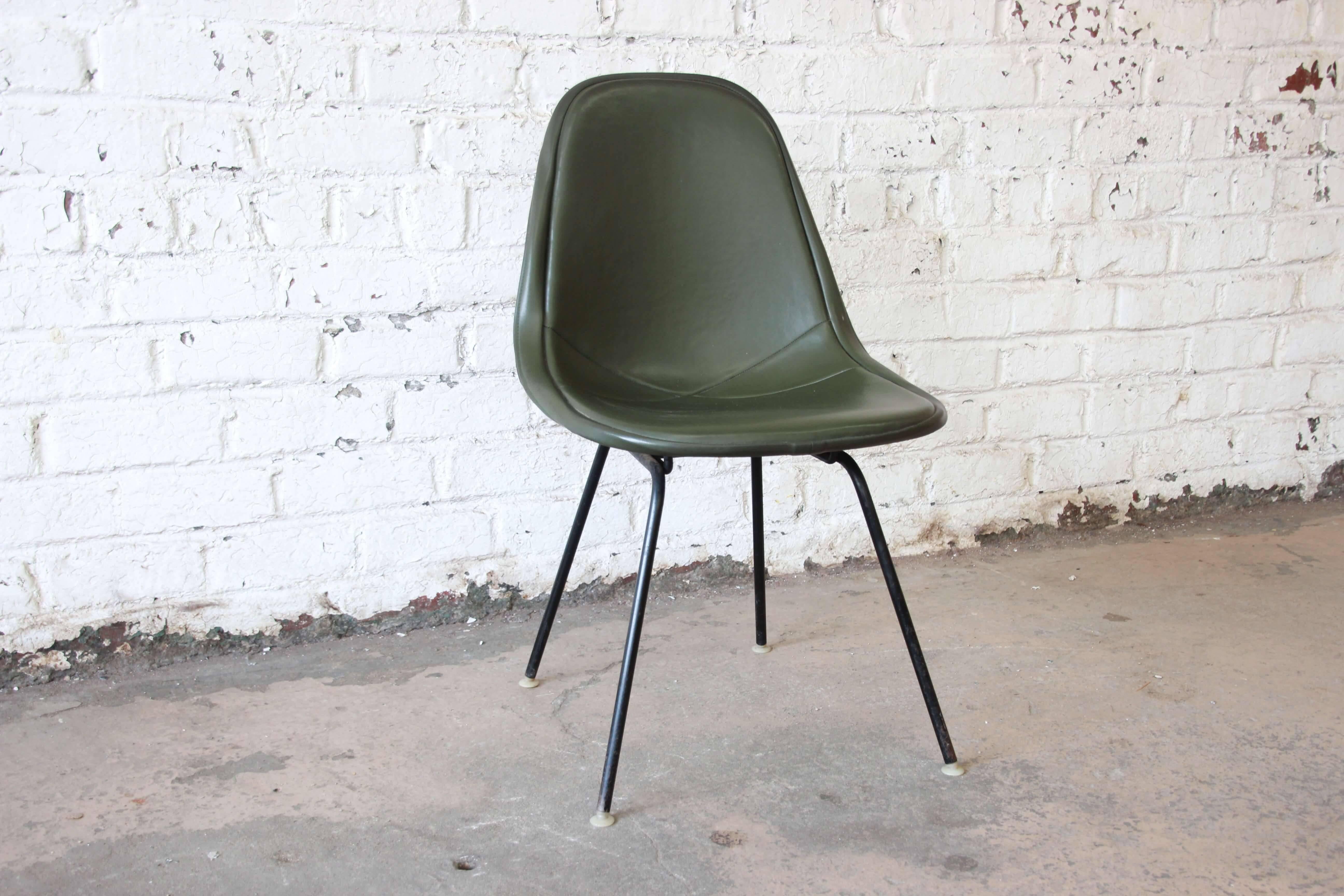 Offering a very nice original Ray and Charles Eames DKX-1 side chair in army green for Herman Miller. The chair features a wire frame and a comfortable cushioned upholstery. The chair is in good vintage condition with a minor nick in the upholstery