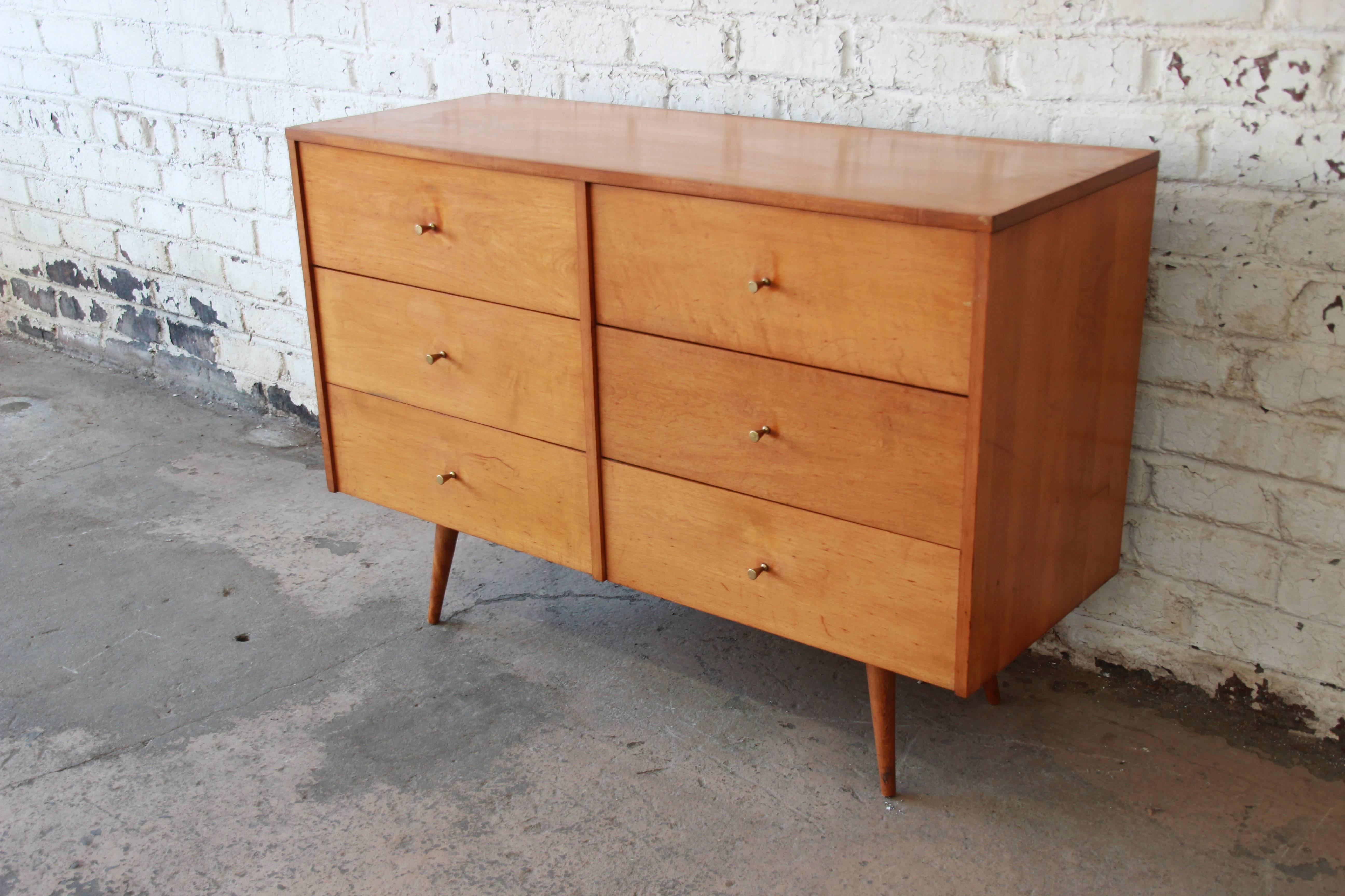 A beautiful original Paul McCobb six-drawer dresser. The dresser features solid birch wood construction and sleek midcentury design. It offers ample room for storage, with six deep drawers. This iconic dresser was designed by Paul McCobb for