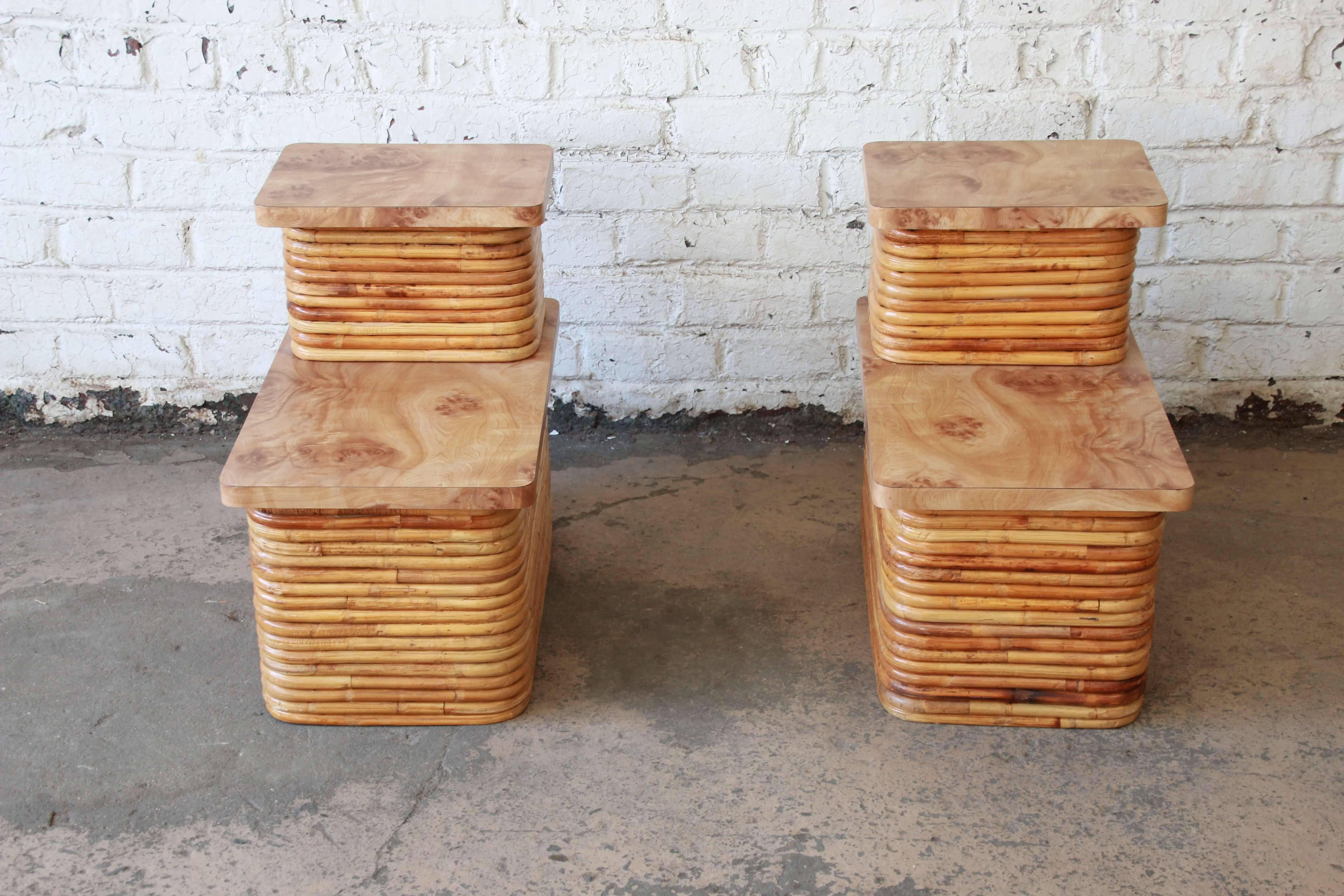 Offering an exceptional pair of bamboo end tables in the style of Paul Frankl. The pair of tables have a two-tier faux burl wood surface providing sufficient space to place items and even lamps. They have great midcentury design and would fit any