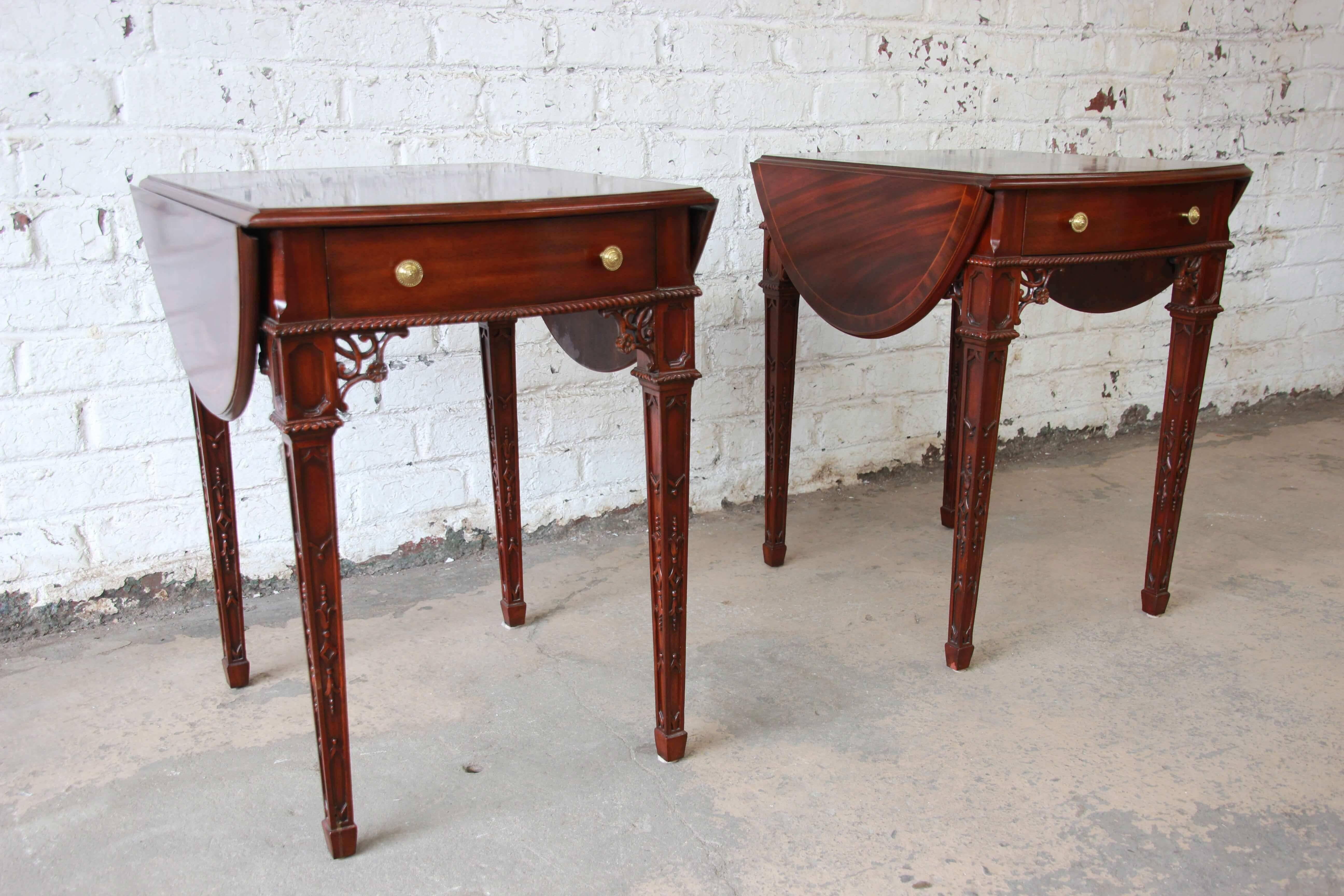 Offering an exceptional pair of mahogany drop-leaf end tables by Maitland-Smith. The tables have a very nice flame mahogany finish at the top and the drop-leafs easily extend for additional surface space. Each table has a drawer for storage and