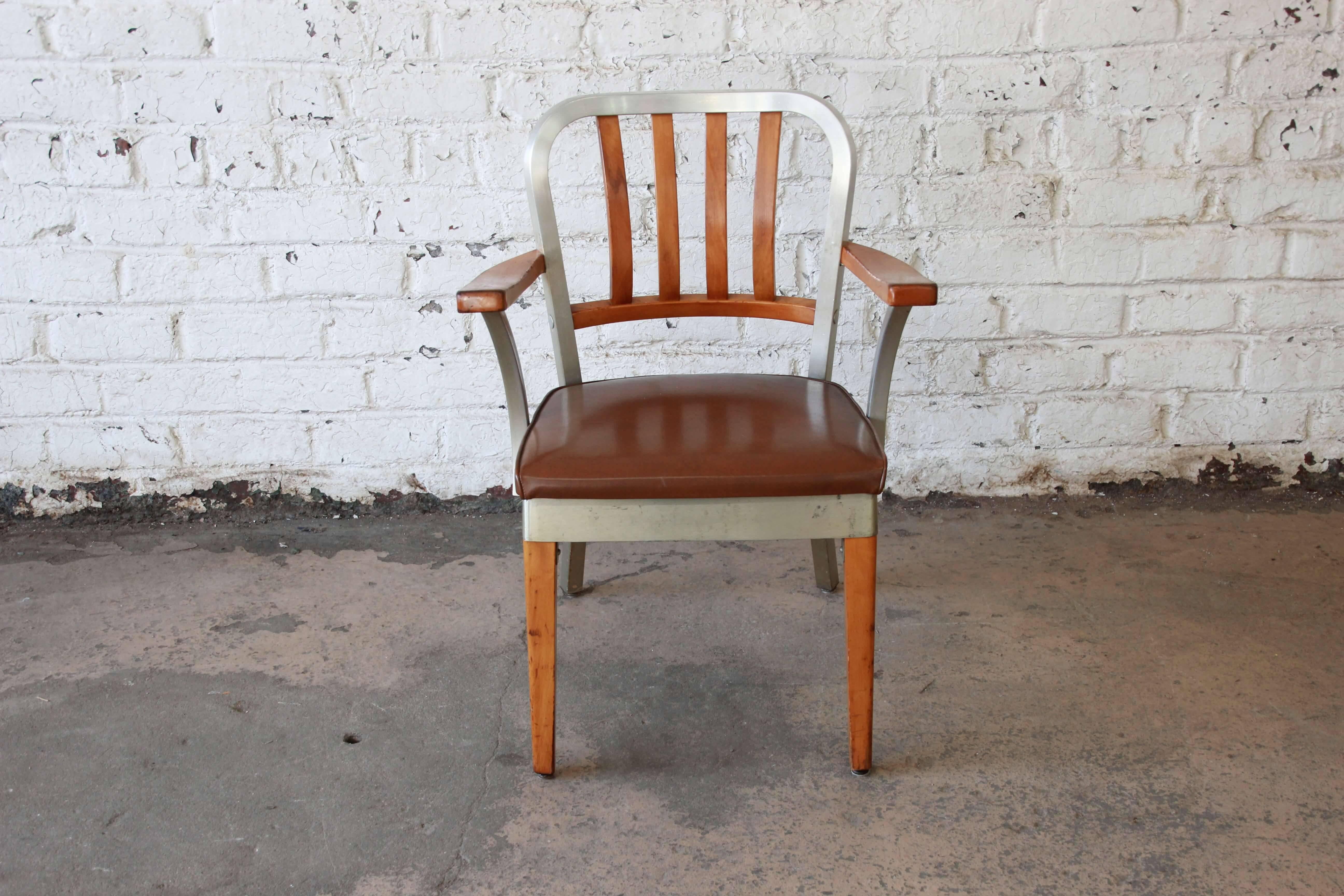 Offering a very nice vintage maple and aluminum chair by Shaw Walker. This chair uniquely has an aluminum frame with solid wood front legs, armrest, and back slats. It has brown leather upholstery and is in great vintage condition.