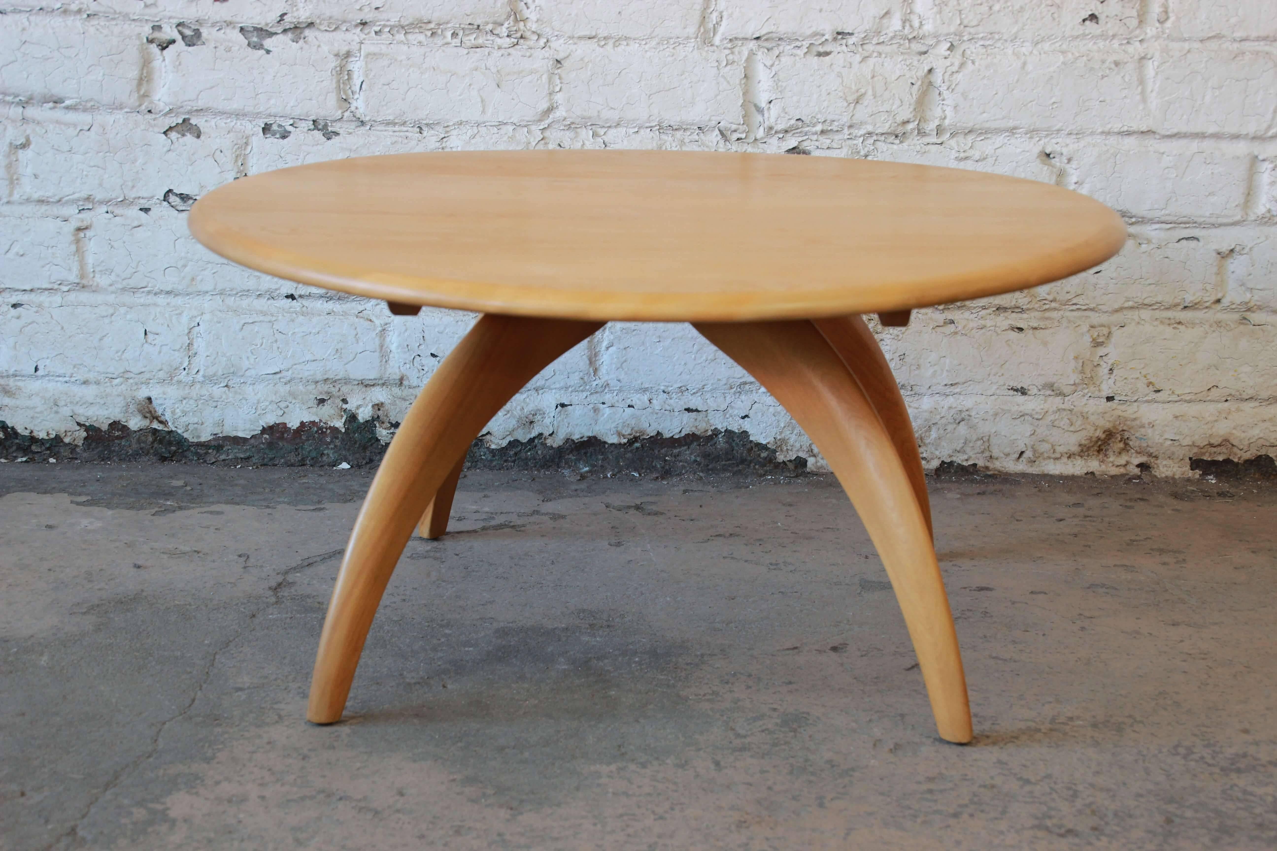 Offering a very nice Heywood-Wakefield Lazy Susan round coffee table. The table has nice wishbone legs that offer great midcentury style. The solid wood tabletop gently spins around as a unique feature. The table is in good vintage condition.