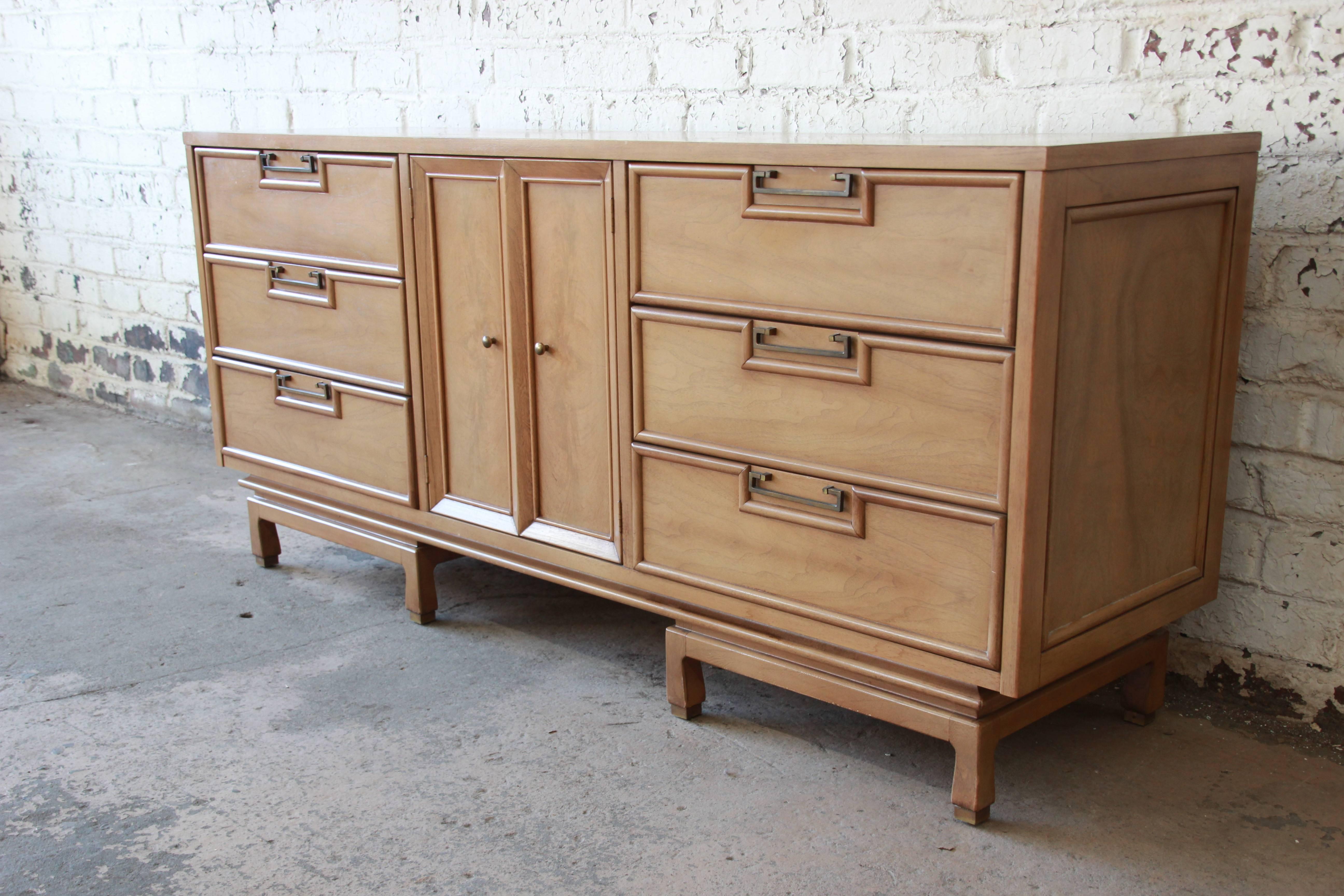 An exceptional Mid-Century Modern Hollywood Regency Chinoiserie style credenza or triple dresser by Merton Gershun for American of Martinsville. This stunning piece features sleek Mid-Century Modern design and beautiful bleached walnut wood grain.