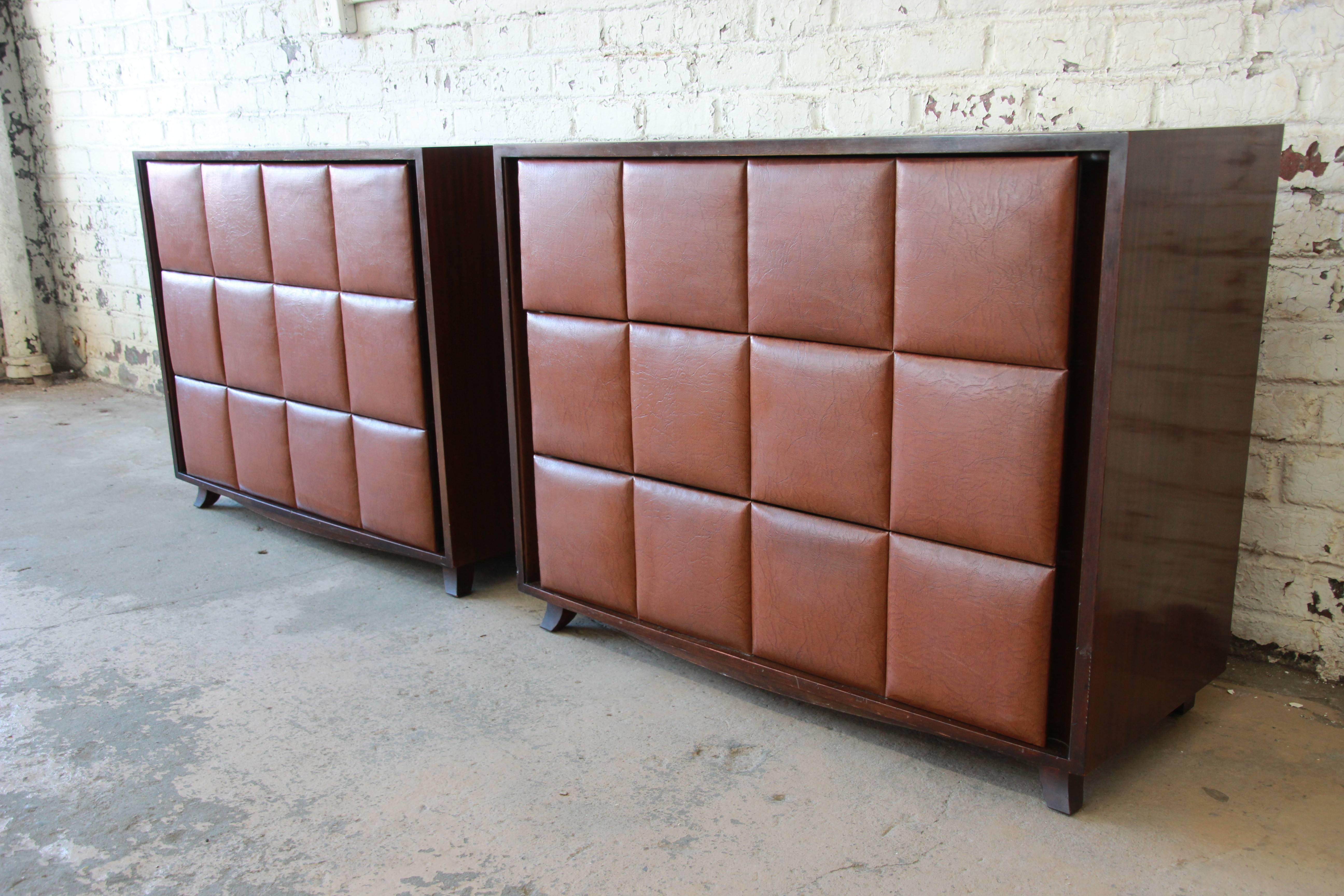 An outstanding pair of three-drawer chests designed in the 1930s by Gilbert Rohde for Herman Miller. The chests feature gorgeous mahogany cabinets with original padded Naugahyde drawer fronts. They offer ample room for storage with three deep