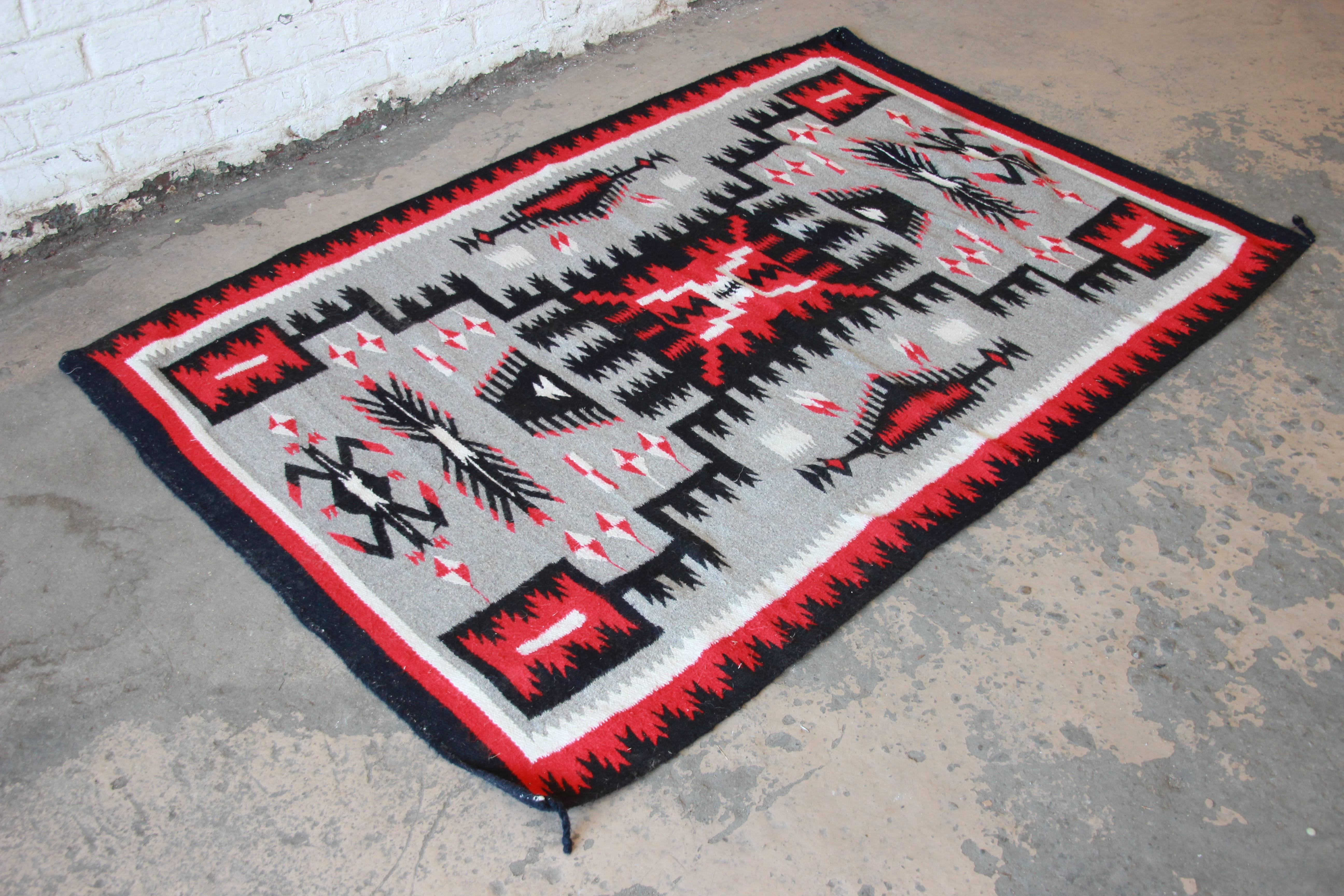 Offering a gorgeous vintage Navajo wool rug. The rug features a unique geometric design, with a gray field and black, red, and white accent colors. The weaving consists of naturally dyed, homespun yarn. Likely woven, circa 1920s. The perfect