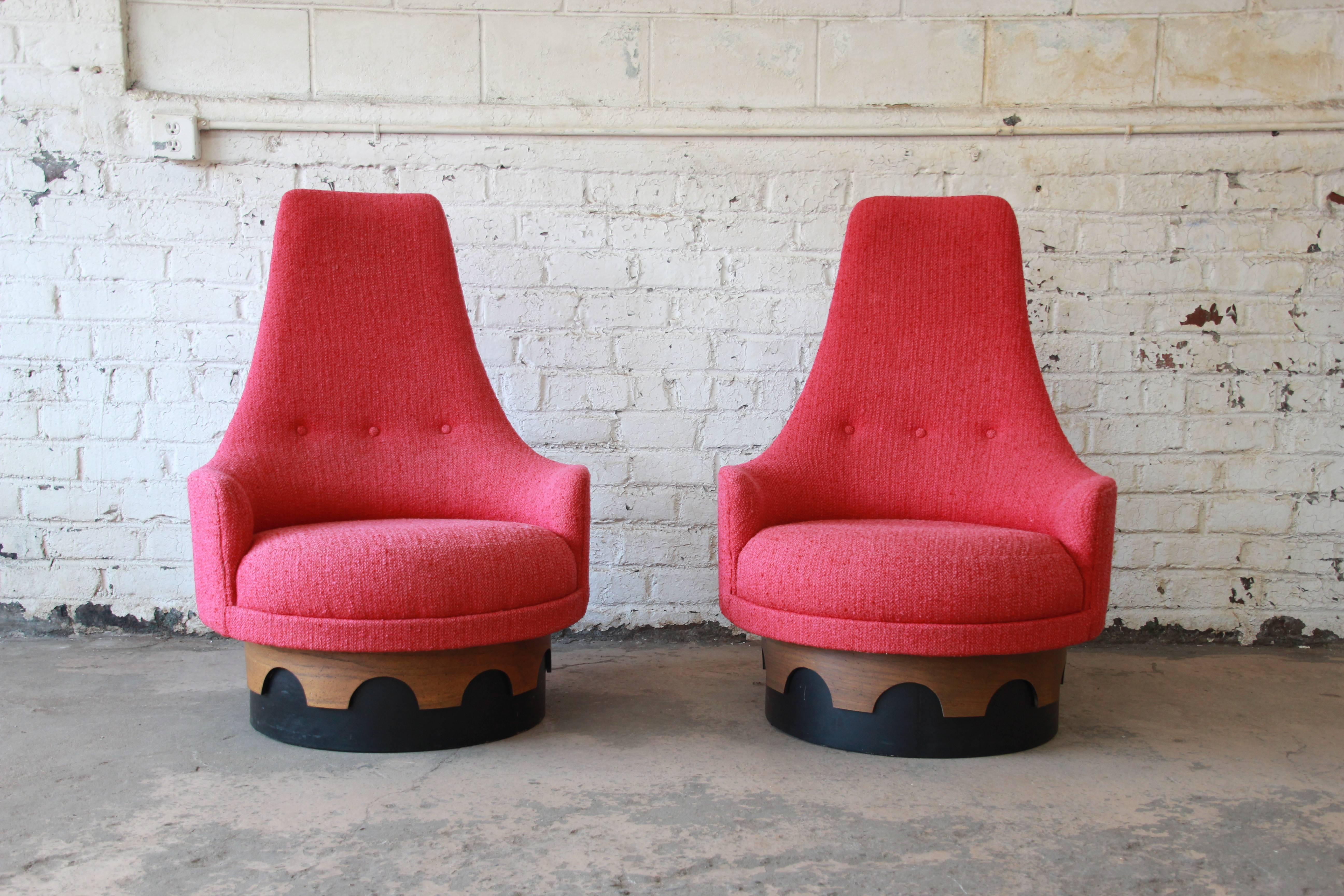 An outstanding original pair of 1960s high back swivel chairs designed by Adrian Pearsall for his “Strictly Spanish” collection for Craft Associates. The chairs feature original hot pink tweed upholstery and a plinth base with two-toned design that