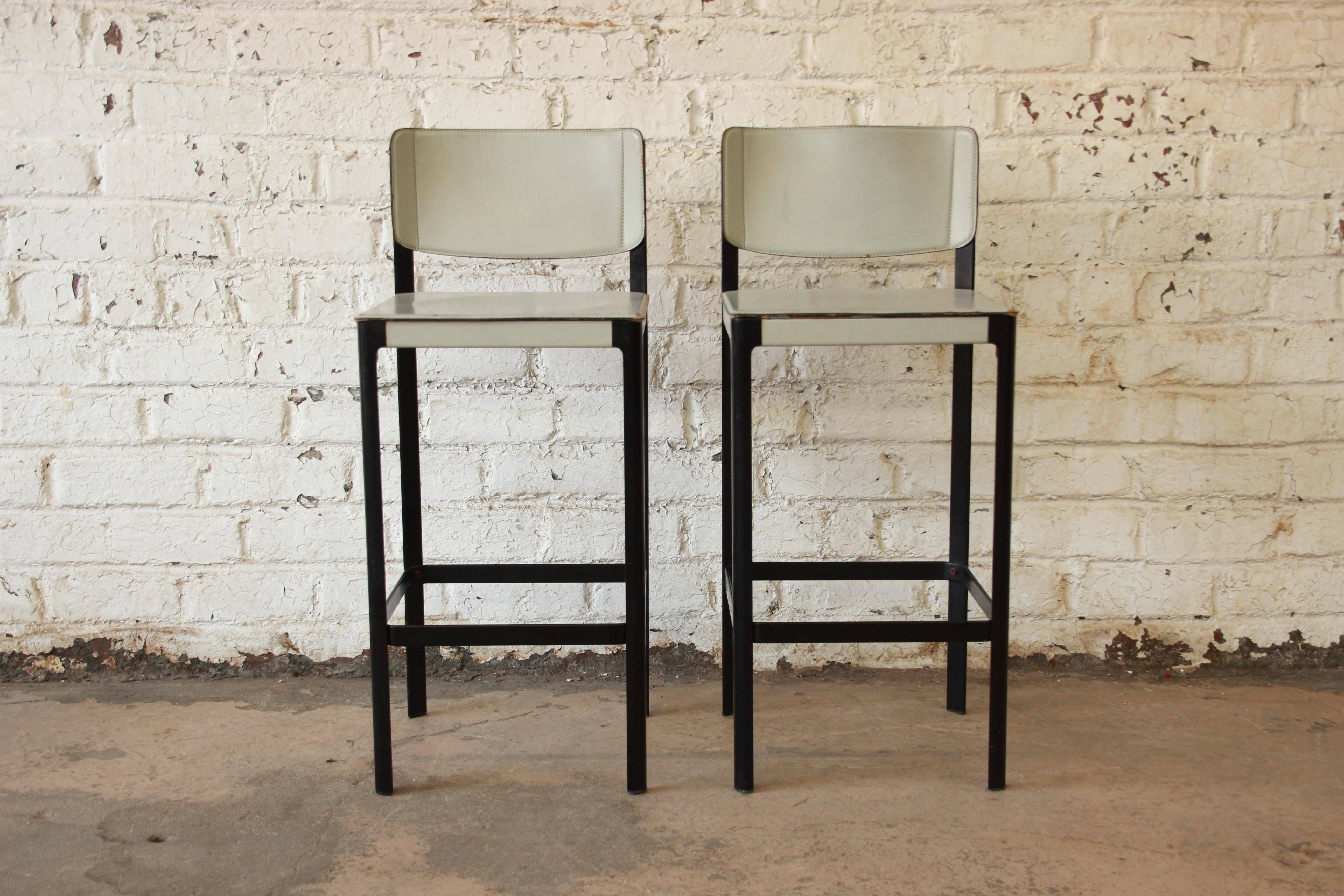 A stunning pair of Sistina Italian leather bar stools by Matteo Grassi. The stools are upholstered in hand-stitched coach hide leather, over black aluminium frames, with unique impressed circular seats. Each stool has "Matteograssi"