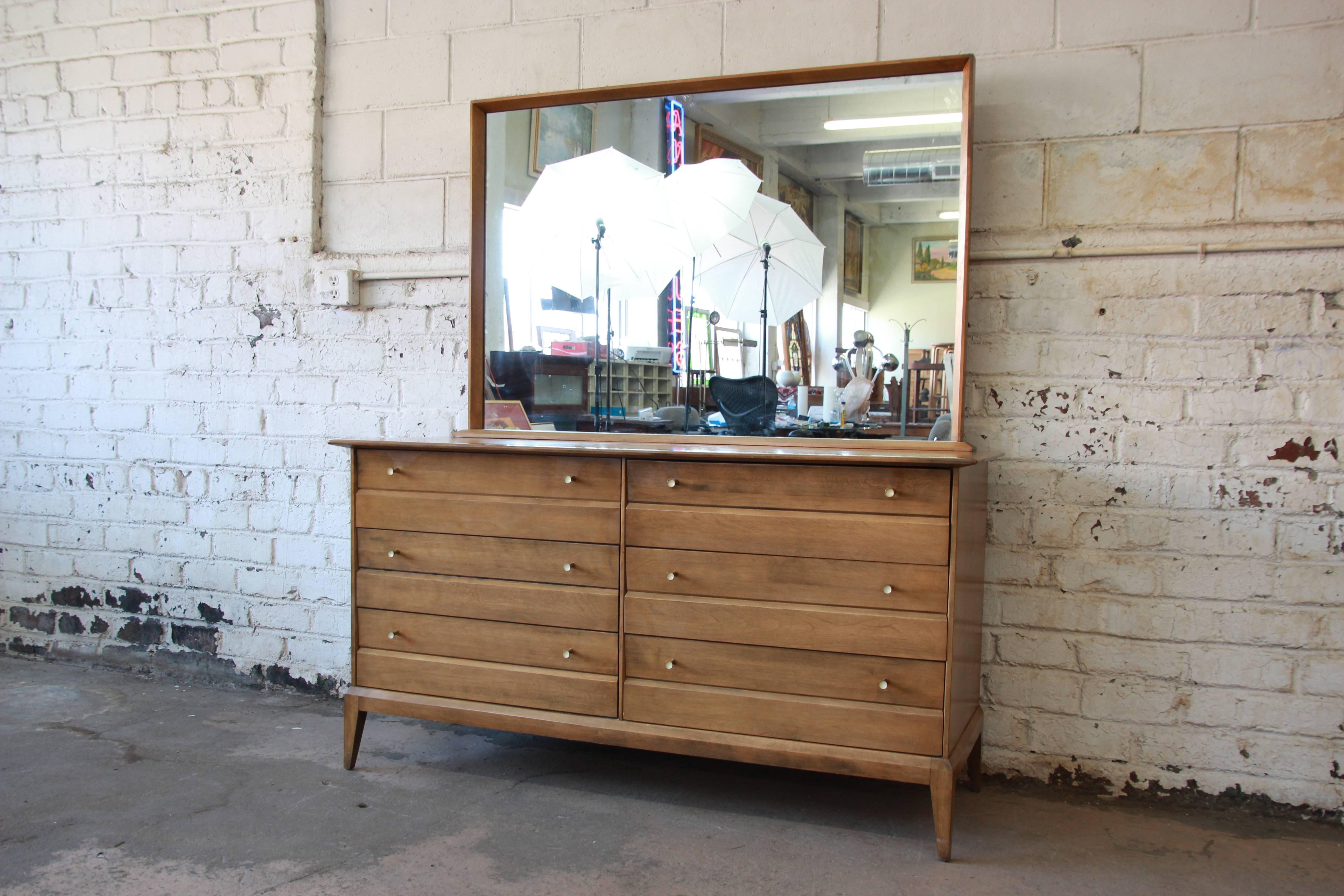 A beautiful vintage six-drawer Mid-Century Modern dresser with mirror from the Cadence line by Heywood Wakefield. The dresser features clean, sleek Mid-Century design and solid maple construction in the 