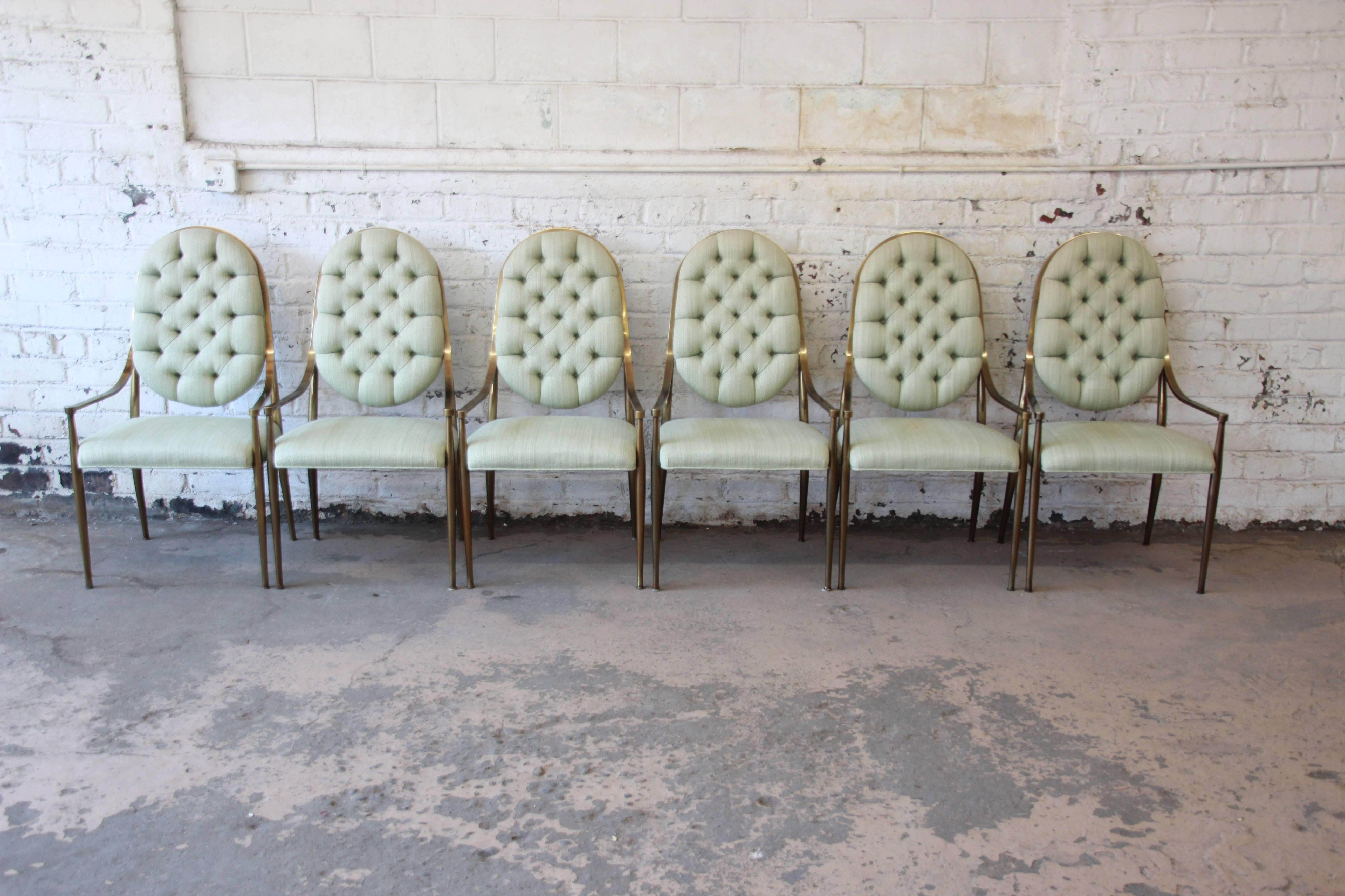 An outstanding set of six 1970s Hollywood Regency style brass dining chairs by Mastercraft. The chairs feature slender but sturdy brass frames with beautiful tufted upholstery in duck egg green. An exceptional and unique set in very good vintage