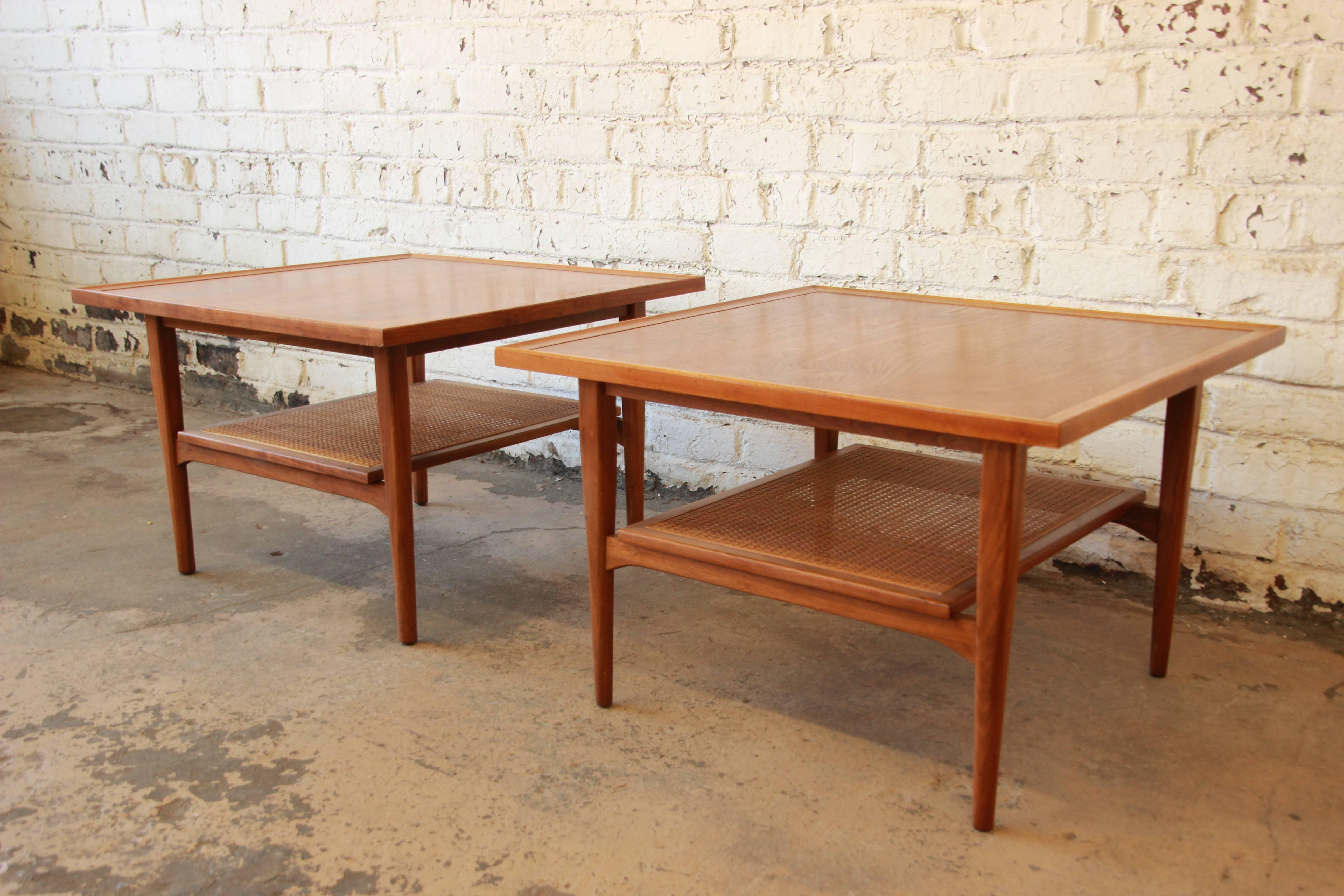 A stylish pair of Mid-Century Modern walnut side tables designed by Kipp Stewart & Stewart MacDougall for Drexel's 