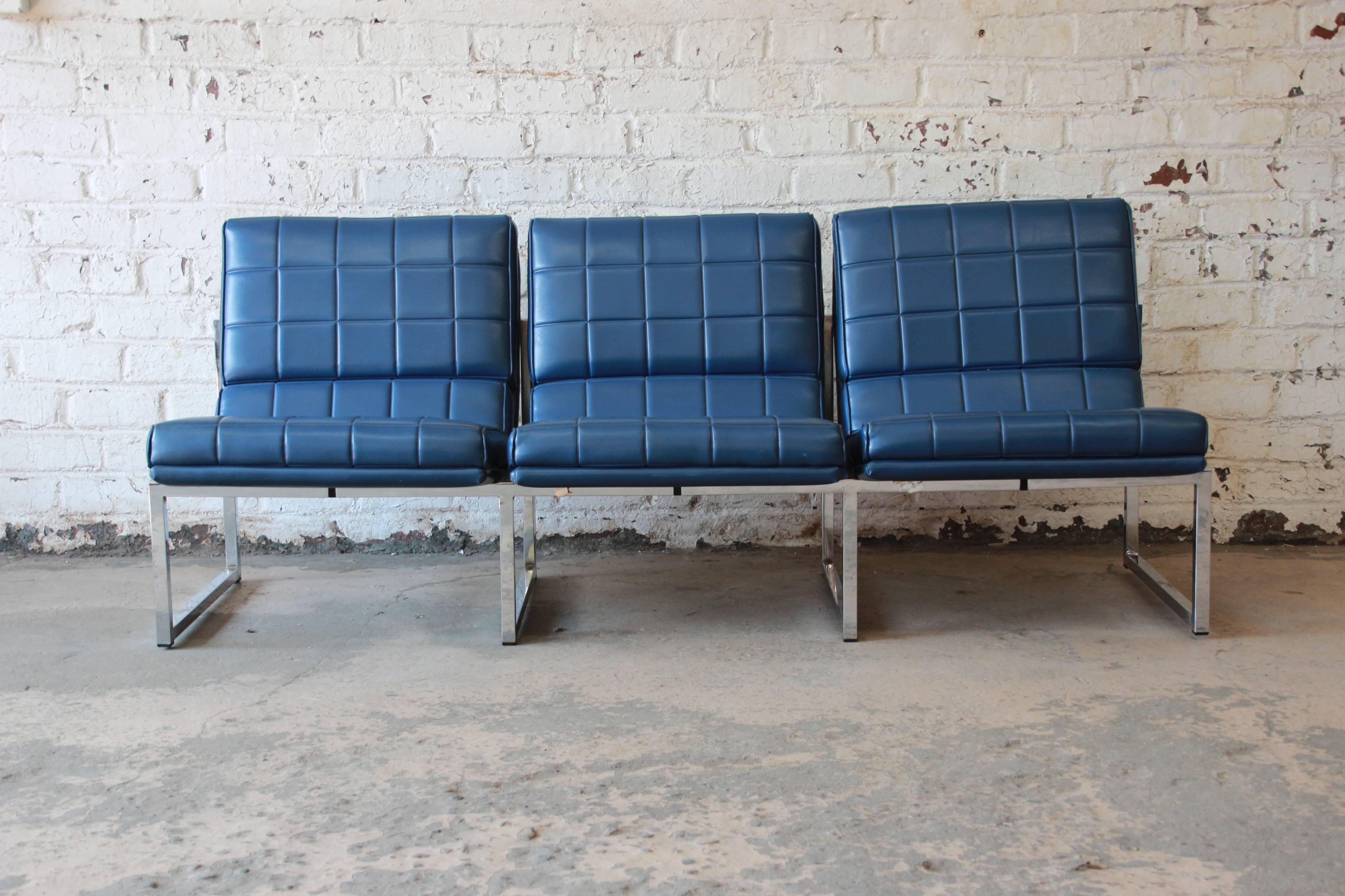 An outstanding 1970s three-seat sofa by Chromcraft. Very much in the style of iconic designer Milo Baughman, with a chrome base and modern lines. The blue vinyl upholstery is in good original condition. Foam is soft and comfortable. A nice